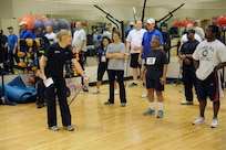 Strength conditioning coach, Heather Pennington provides instruction to participants during the Air Force Adaptive Fitness and Sports Camp on how to keep their balance whilel performing strength conditioning exercises on Joint Base San Antonio-Randolph Jan. 20. ( U.S. Air Force photo by Don Lindsey) (released)