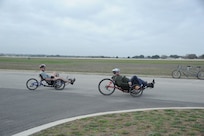 Claude Owens (left) and Tony Simone, Adaptive Fitness and Sports Camp participants practice on recumbant bikes at Eberle Park on Joint Base San Antonio-Randolph Jan. 19. Forty five Air Force, Navy and U.S. Special Operations Command Wounded Warriors participated in the inaugural Adaptive Fitness & Sports Camp held at JBSA- Randolph  Jan. 18-21. Events included wheelchair basketball, sitting volleyball, cycling, aquatics, strength and conditioning, adaptive bowling and golf opportunities. (U.S. Air Force photo/Rich McFadden) (released)