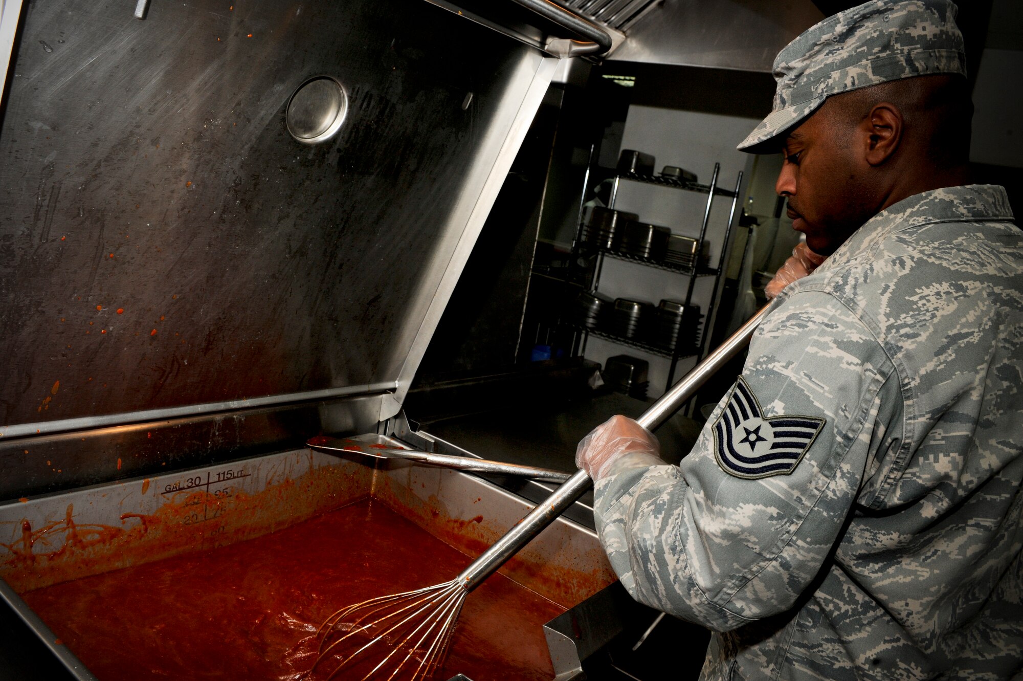 Tech. Sgt. David Bushnell, 332nd Expeditionary Force Support Squadron, prepares tomato soup in the Huntley Dining Facility at an undisclosed location in Southwest Asia, Jan. 21, 2012. Although the dining facility is open 24/7, 'hot meals' are only served during specific times. Bushnell is deployed from Davis-Monthan Air Force Base, Ariz., and is a native of Eunice, La. (U.S. Air Force photo by Staff Sgt. Joshua J. Garcia/Released)