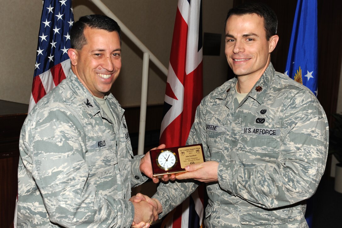 RAF CROUGHTON, United Kingdom - Maj. Byron Greene, 422nd Air Base Group Judge Advocate, accepts the 501st Combat Support Wing Fourth Quarter Civilian Volunteer Award for Abbi Sandford (not pictured). (U.S. Air Force photo by Tech. Sgt. John Barton)