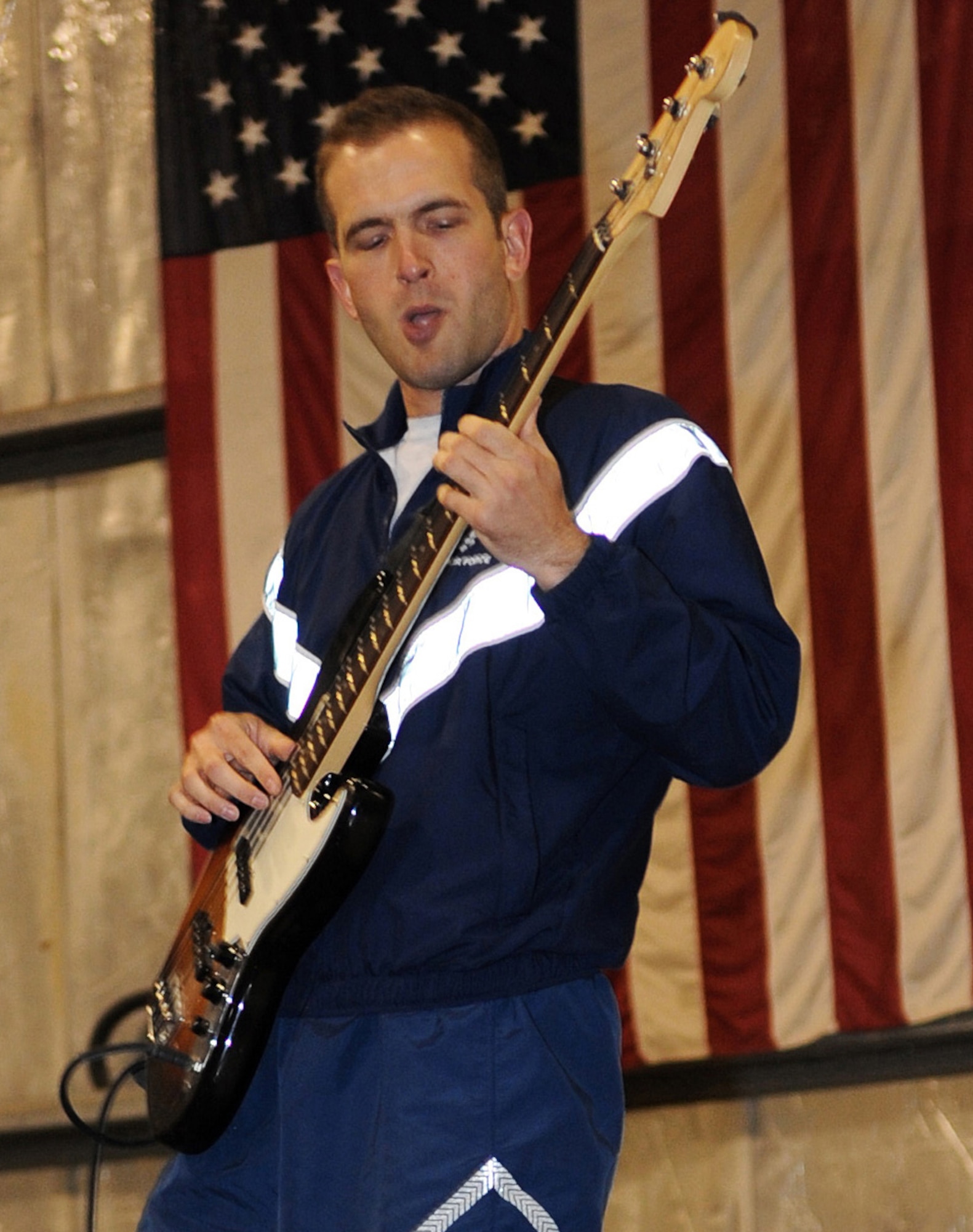 SOUTHWEST ASIA - Capt. Keith Earley plays bass with Afterburner, the Air Forces Central Band, Jan. 21, 2012. During their three-day, nine-show visit to the 380th Air Expeditionary Wing, several local Airmen performed with the band. Earley, deployed from Tinker Air Force Base, Okla., played bass on "The Distance" and "Brown-eyed Girl." (U.S. Air Force photo/Staff Sgt. J.G. Buzanowski)