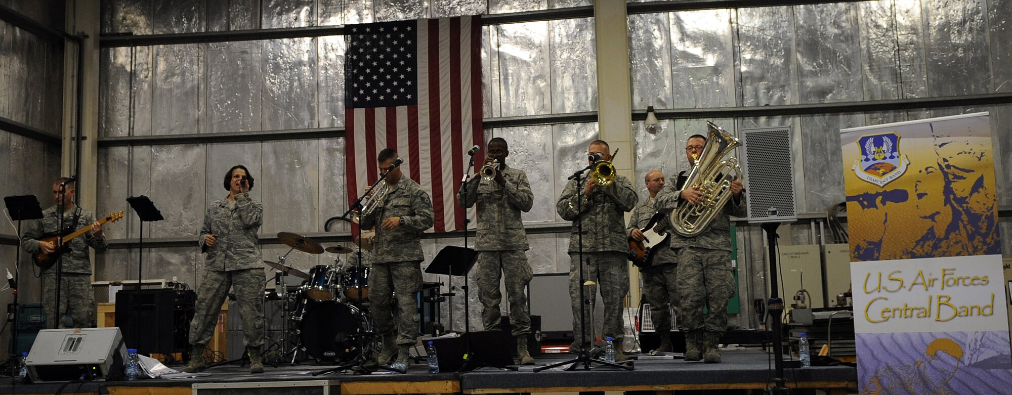 SOUTHWEST ASIA - Afterburner, the Air Forces Central Band, performs for Airmen at the aerospace ground equipment hangar Jan. 21, 2012. During their three-day, nine-show visit to the 380th Air Expeditionary Wing, the band performed several sets and even featured local Airmen on stage with them. Afterburner has performed more than 60 shows for thousands of service members and civilians in five countries since Dec. 1, 2011. (U.S. Air Force photo/Staff Sgt. J.G. Buzanowski)