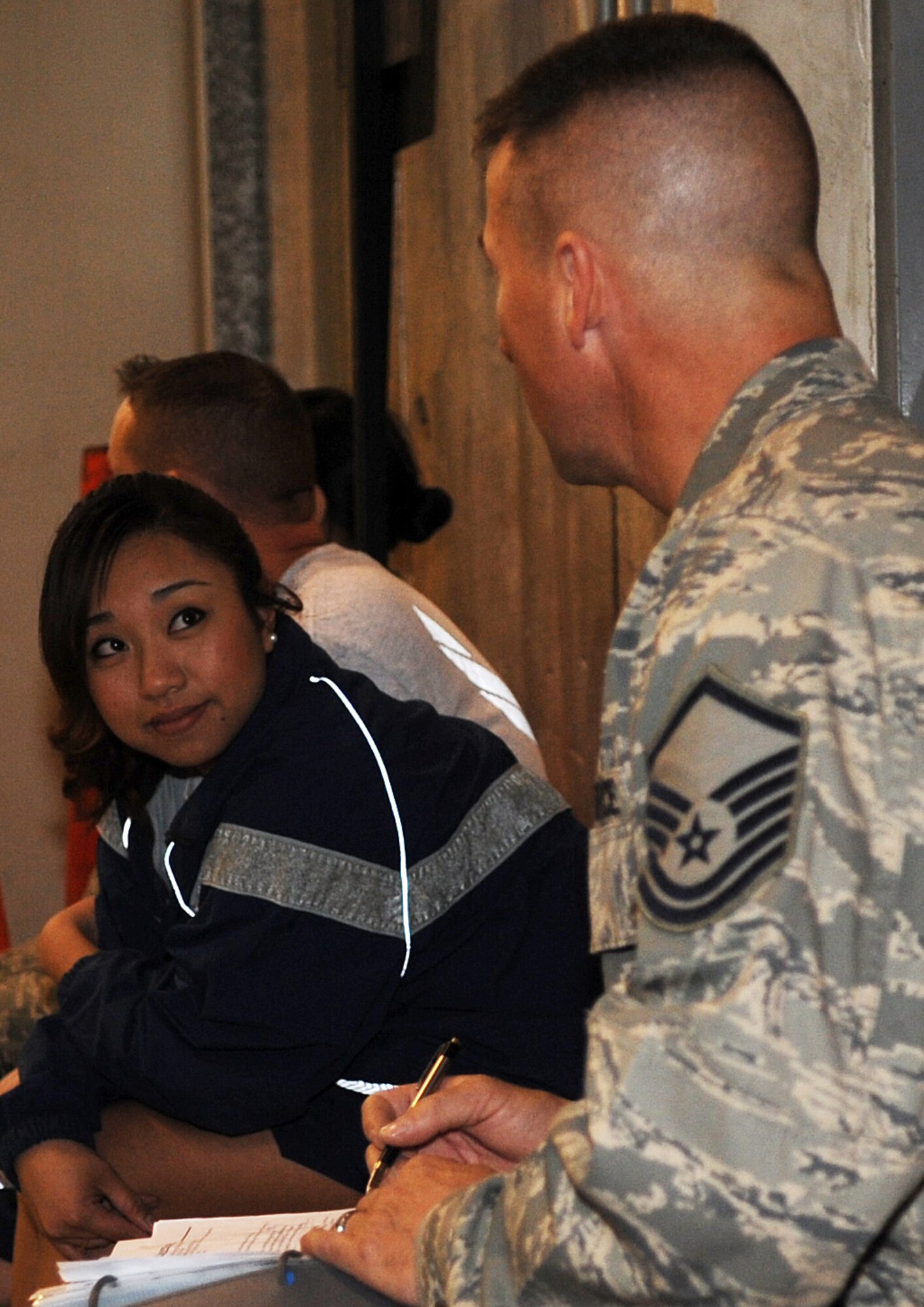 SOUTHWEST ASIA - Senior Airman Alora Aguelo reviews a set list with Master Sgt. Ted Stearns before performing for 380th Air Expeditionary Wing Airmen Jan. 21, 2012. Stearns is a member of Afterburner, the Air Forces Central Band. During their three-day, nine-show visit to the 380th AEW, several local Airmen performed with the band. Aguelo, deployed from Scott Air Force Base, Ill., sang "Proud Mary."  (U.S. Air Force photo/Staff Sgt. J.G. Buzanowski)