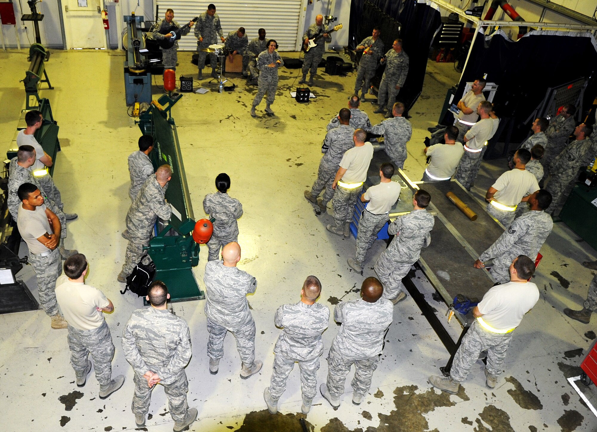 SOUTHWEST ASIA - Afterburner, the Air Forces Central Band, performs for Airmen assigned to the fabrication flight Jan. 21, 2012. During their three-day, nine-show visit to the 380th Air Expeditionary Wing, the band performed acoustic sets for Airmen who wouldn?t be able to make their other shows. Afterburner has performed more than 60 shows for thousands of service members and civilians in five countries since Dec. 1, 2011. (U.S. Air Force photo/Staff Sgt. J.G. Buzanowski)