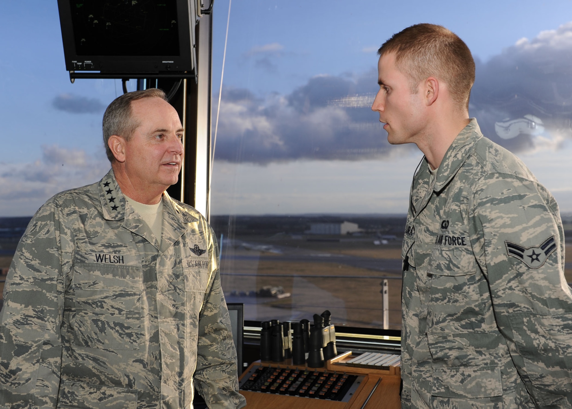 RAF MILDENHALL, England -- Gen. Mark A. Welsh III, U.S. Air Forces in Europe
commander, listens to Airman 1st Class Patrick Lura, 100th Operations
Support Squadron air traffic controller, during his visit to the aircraft
control tower here Jan. 19, 2012. Welsh was at the base to meet Airmen and
brief base leadership on upcoming changes and challenges in the command.
(U.S. Air Force photo/Tech. Sgt. Neal X. Joiner) 
