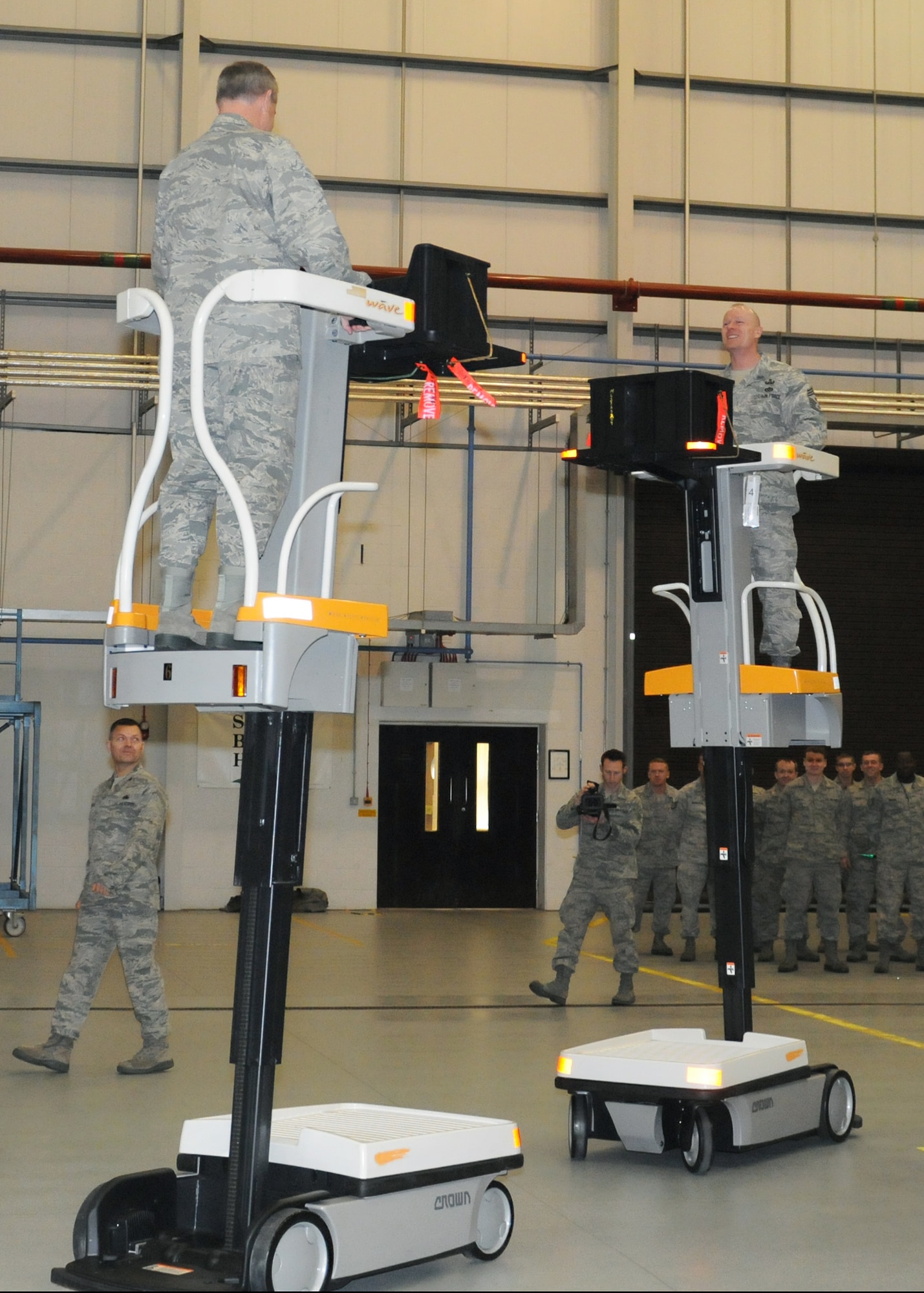 RAF MILDENHALL, England -- Gen. Mark A. Welsh III, U.S. Air Forces in Europe
commander, and Chief Master Sgt. David Williamson, USAFE command chief, test
drive work assist vehicles (WAVE) Jan. 19, 2012 at Hanger 814. RAF
Mildenhall was the first Air Force base to start using the WAVE in 2009
after an Air Force Smart Operations for the 21st Century event. The
adjustable height and mobility of the lift saves time by allowing
maintainers to adjust height and position without dismounting the vehicle.
(U.S. Air Force photo/Staff Sgt. Tabitha M. Lee)
