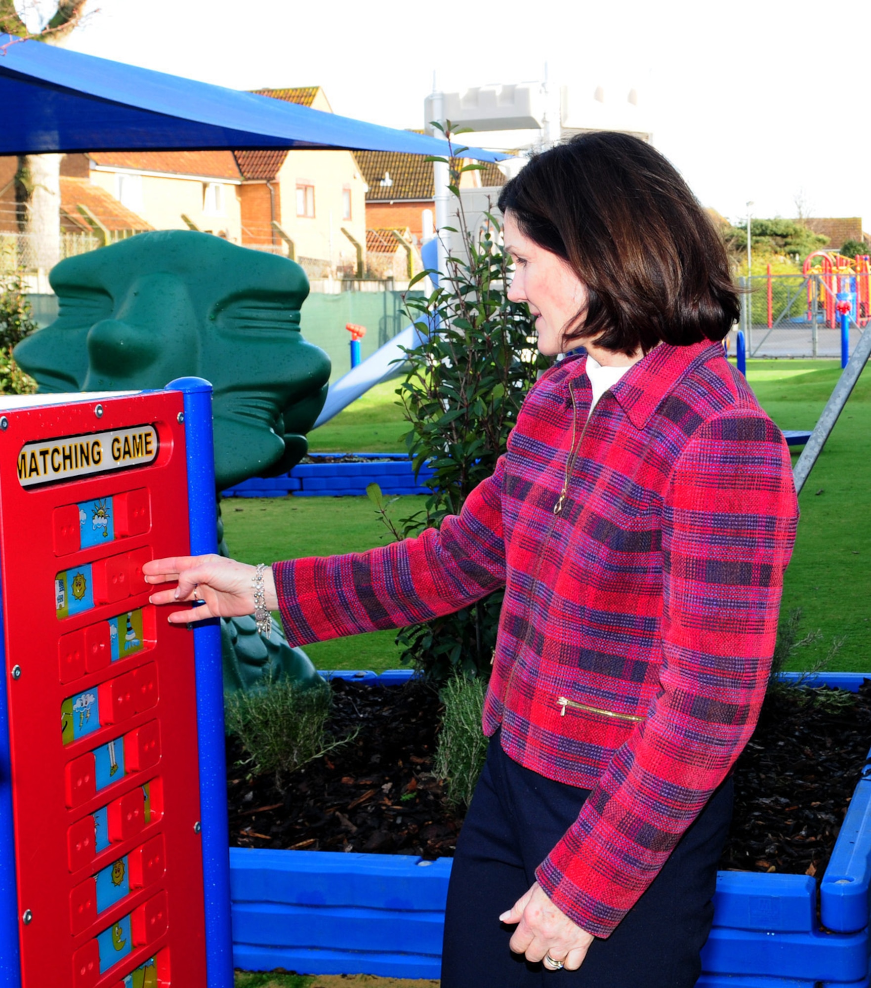 RAF MILDENHALL, England -- Betty Welsh, wife of Gen. Mark A. Welsh III, U.S. Air Forces in Europe commander, takes a look at equipment in the new playground at the RAF Mildenhall Child Development Center Jan. 19, 2012. Mrs. Welsh visited the CDC, along with Mary Williamson, wife of Chief Master Sgt. David Williamson, USAFE command chief. They were shown around the facility and the youth center where staff talked to them about services they offer and the benefits of children attending. (U.S. Air Force photo/Karen Abeyasekere)

