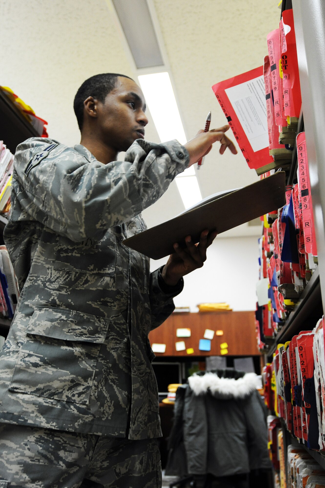 MISAWA AIR BASE, Japan -- Airman 1st Class Tahj Fuller, 35th Medical Support Squadron outpatient records technician, checks and files records during an audit here, Jan. 19. Outpatient records service members audit records annually to ensure they have all medical records of active duty Air Force members assigned to Misawa. (U.S. Air Force photo/Airman 1st Class Kia Atkins)