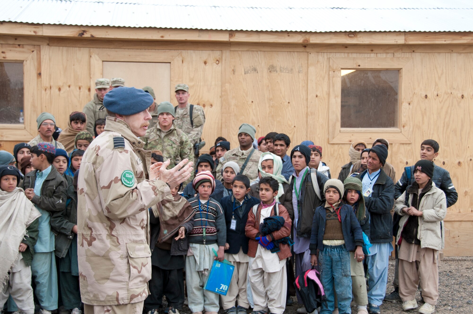 KANDAHAR AIRFIELD, Afghanistan -- Netherlands Col. Kees Marselis, Kandahar Airfield chief of staff, speaks to the attendees and bazaar school children during the bazaar school ribbon-cutting ceremony at Kandahar Airfield, Afghanistan Jan. 21, 2012. Volunteers from the 809th Expeditionary RED HORSE Squadron rebuilt the school after the school burned down in October 2011. (U.S. Air Force photo by Staff Sgt. David Carbajal)