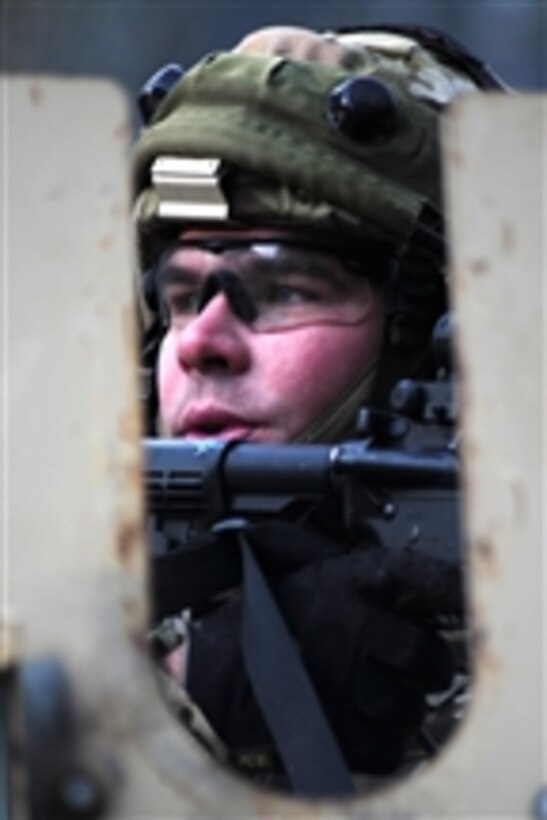 A U.S. Army soldier with an operational mentor and liaison team scans for opposing forces out of a gunner hatch during training at the Joint Multinational Readiness Center in Hohenfels, Germany, on Jan. 17, 2012.  Ten operational mentor and liaison teams took part in 17 days of training designed to prepare them for critical missions in support of Afghanistan's security.  The training prepared the mentor and liaison teams to deploy to Afghanistan and work with Afghan National Army soldiers.  