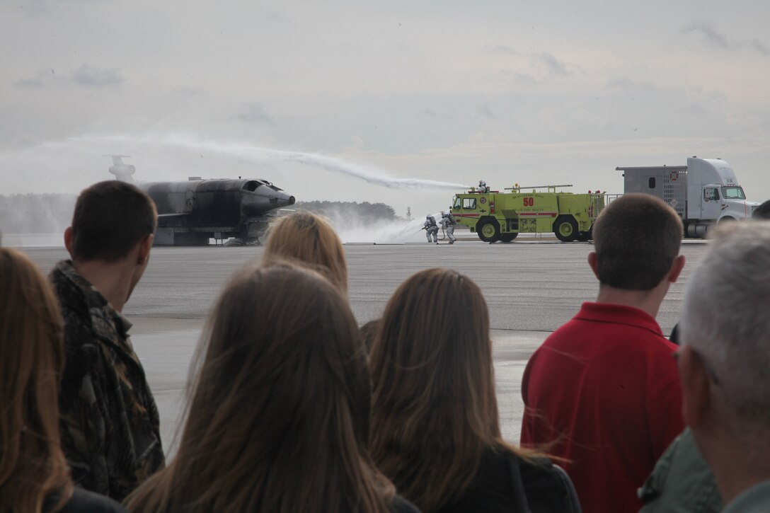 Students from Pamlico County High School watch a demonstration of the abilities of Marine Corps Air Station Cherry Point Aircraft Rescue Firefighting during their tour of MCAS Cherry Point Jan. 24. The 53 students stopped at three locations on MCAS Cherry Point and were given tours of the facilities along with detailed explanations of each unit’s mission. "It's good for the students to come here and see what we do, and we get to give a class on fire safety while they're here," said Cpl. Gary Meadows, a crew chief with ARFF. "Having an audience gives us a chance to do some of the things we don't normally do, like wet runs and taking the trucks out. It lets us brag about how cool our job is."