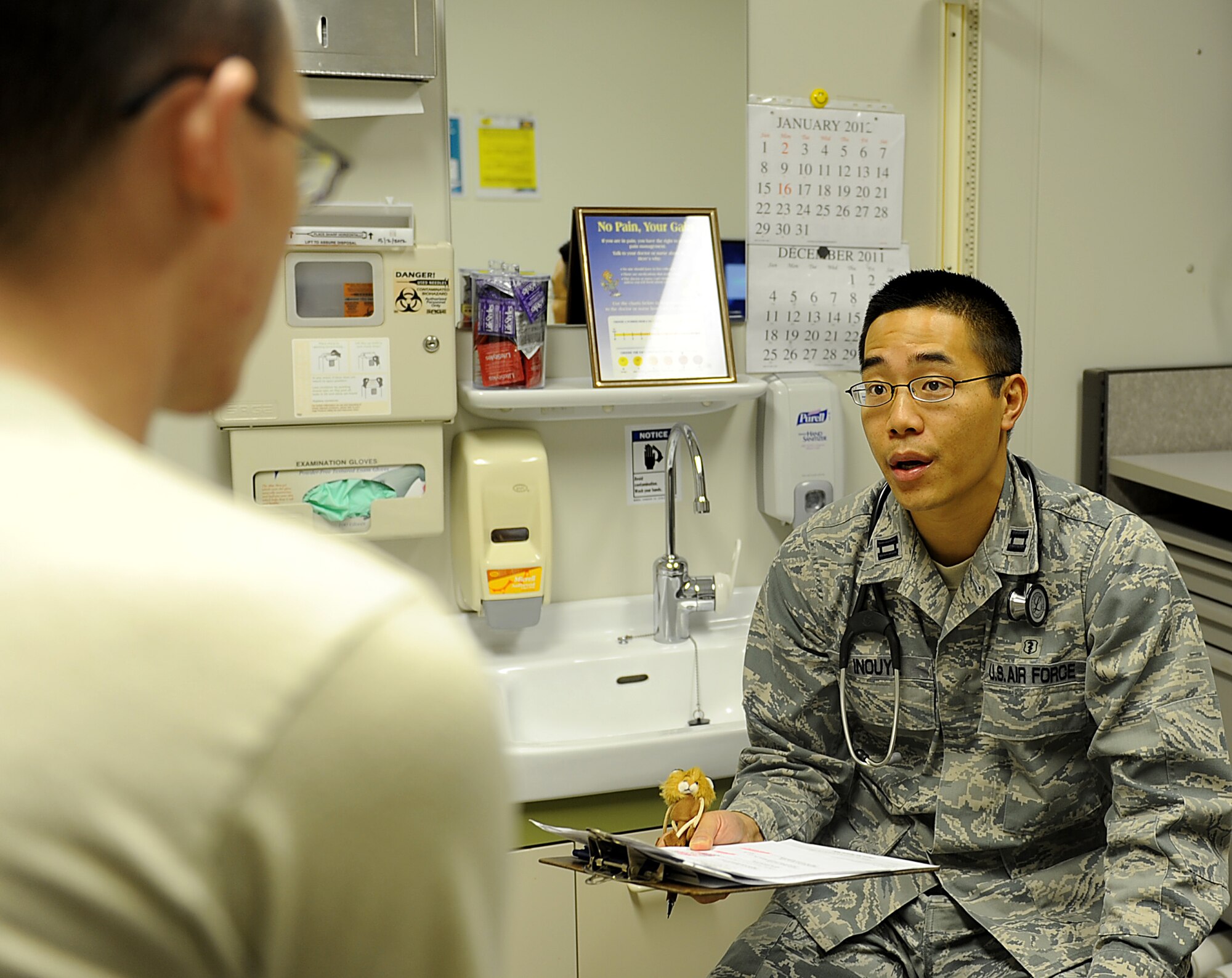 U.S. Air Force Dr. (Capt.) Jordan Inouye, 18th medical group family practice physician, talks to a patient during an appointment at the Kadena clinic, Jan. 25, 2012. Last month, the Kadena Medical Clinic's Family Health Clinic implemented a new initiative, Patient Centered Medical Home, to create an environment that promotes and delivers quality, evidence based care to patients. (U.S. Air Force photo by Airman 1st Class Brooke P. Beers)