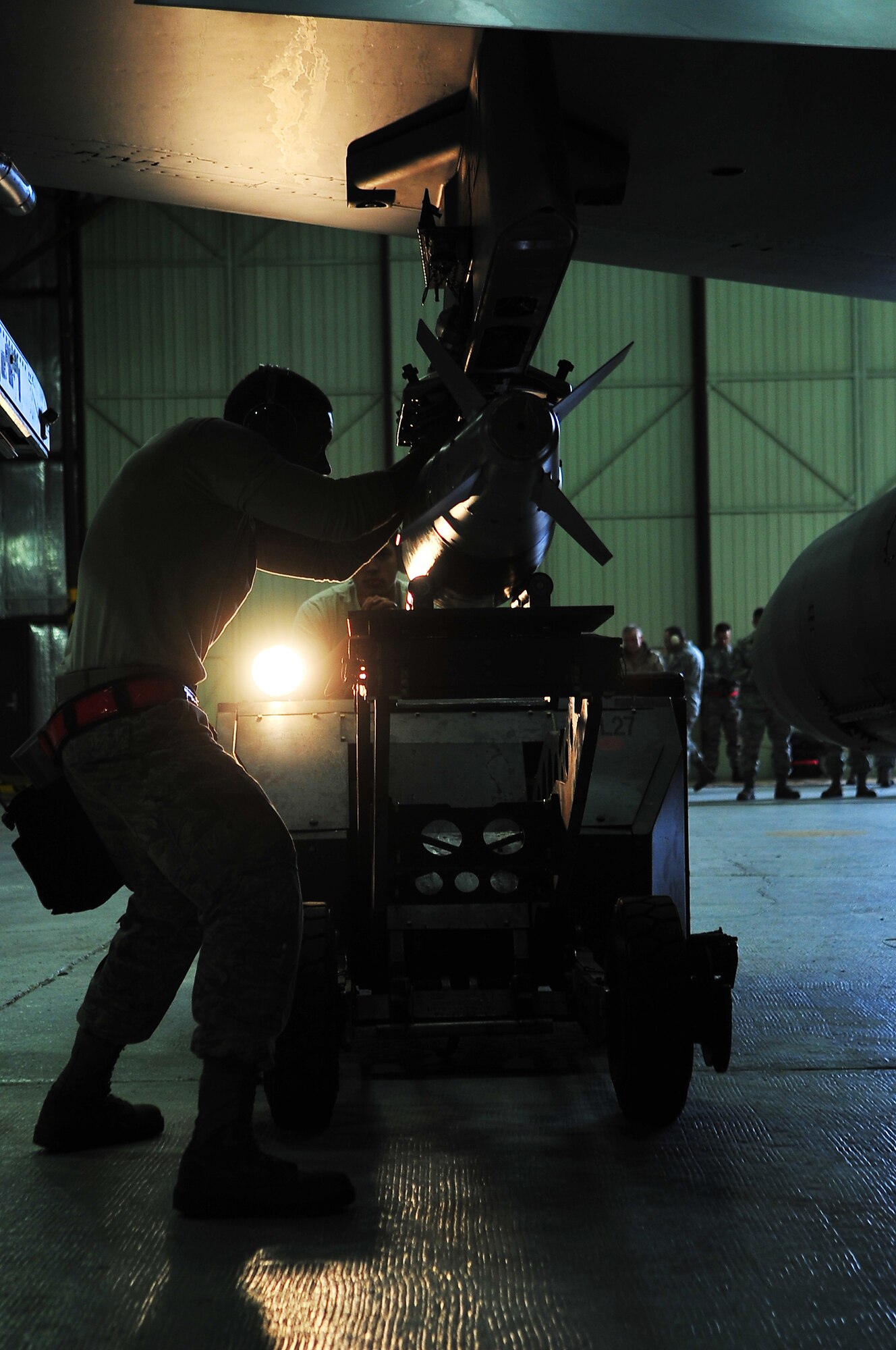 Staff Sgt. Donald Shoals, 36th Aircraft Maintenance Unit weapons load crew member, lines up a GBU-38 bomb on an F-16 Fighting Falcon during the 4th quarter load crew competition Jan 20, 2012 at Osan Air Base. Two teams with the highest statistics and proficiency rates competed against each other. Loaders from the 25th AMU loaded munitions onto an A-10 Thunderbolt and the 36th AMU loaded an F-16 Fighting Falcon during the competition. (U.S. Air Force photo/Staff Sgt. Stefanie Torres)