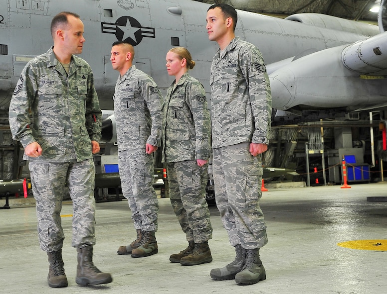 Senior Master Sgt. James Faucette, 25th Aircraft Maintenance Unit weapons superintendent, performs dress and appearance inspections on the 25th AMU load crew team during the 4th quarter competition here Jan. 20, 2012. The 25th AMU won the competition and will go on to compete against other loaders in the Pacific Air Forces. (U.S. Air Force photo/Staff Sgt. Stefanie Torres)