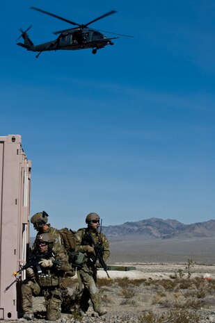 U.S. Air Force pararescuemen, 58th Rescue Squadron, provide security with aerial support from an HH-60 Pavehawk during a combat training mission Jan. 18, 2012, at the Nevada Test and Training Range. Pararescuemen are trained to provide emergency medical treatment in adverse terrain and conditions in combat or peacetime. (U.S. Air Force photo by Airman 1st Class Daniel Hughes/Released)
 