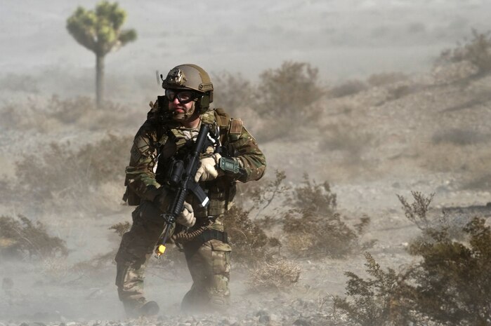A U.S. Air Force pararescueman, 58th Rescue Squadron, secures an area during a combat training mission Jan. 18, 2012, at the Nevada Test and Training Range. Pararescuemen are trained to provide emergency medical treatment in adverse terrain and conditions in combat or peacetime. (U.S. Air Force photo by Airman 1st Class Daniel Hughes/Released)
