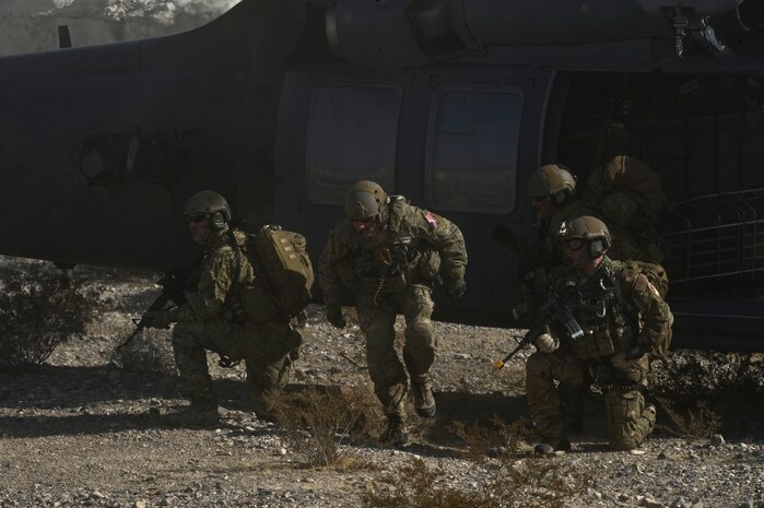 U.S. Air Force pararescuemen, 58th Rescue Squadron, depart from a HH-60 Pavehawk to locate a simulated downed pilot during a combat training mission Jan. 18, 2012, at the Nevada Test and Training Range. Pararescuemen are trained to provide emergency medical treatment in adverse terrain and conditions in combat or peacetime. (U.S. Air Force photo by Airman 1st Class Daniel Hughes/Released)

