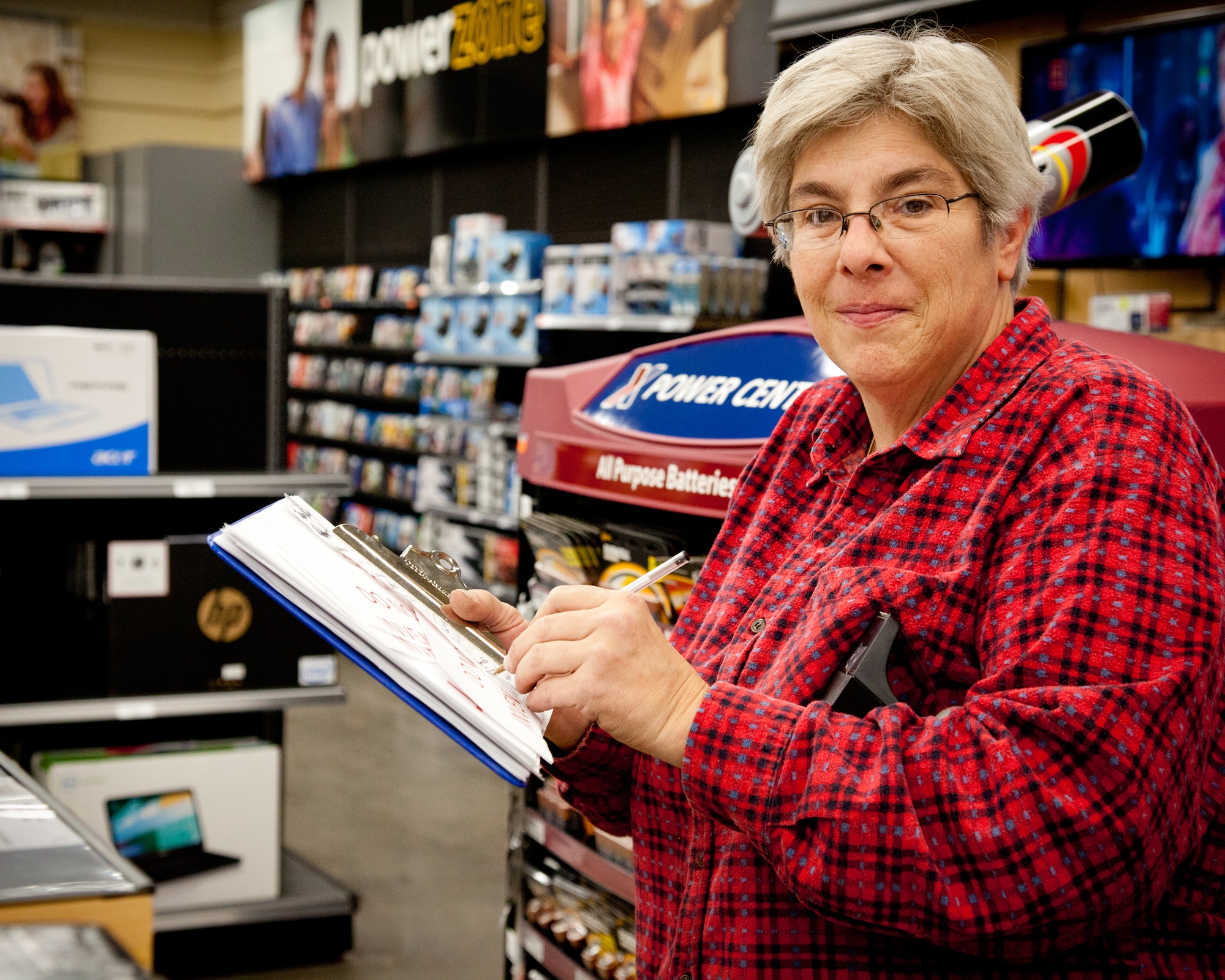 One of many essential people around base during the week, Tammy Dedens works on signing and inventory at the Base Exchange.  The BX is one benefit Airmen and their families can use not only to save money, but also support critical quality of life programs for military communities across the globe. (Air Force Photo/Shannon McKay)