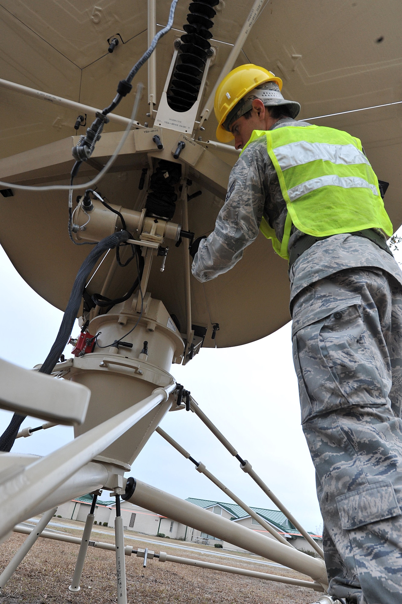 SAVANNAH AIR NATIONAL GUARD BASE, Ga. – Senior Airman Stephen Hill, a 52nd Combat Communications Squadron cyber transmission journeyman, raises a ground multiband terminal here Jan. 24. The unit began its Arctic Gator field training exercise Jan. 24 and will build, operate in and defend a fully functioning bare base communications camp before the exercise ends Feb. 3. (U.S. Air Force photo by Tommie Horton)