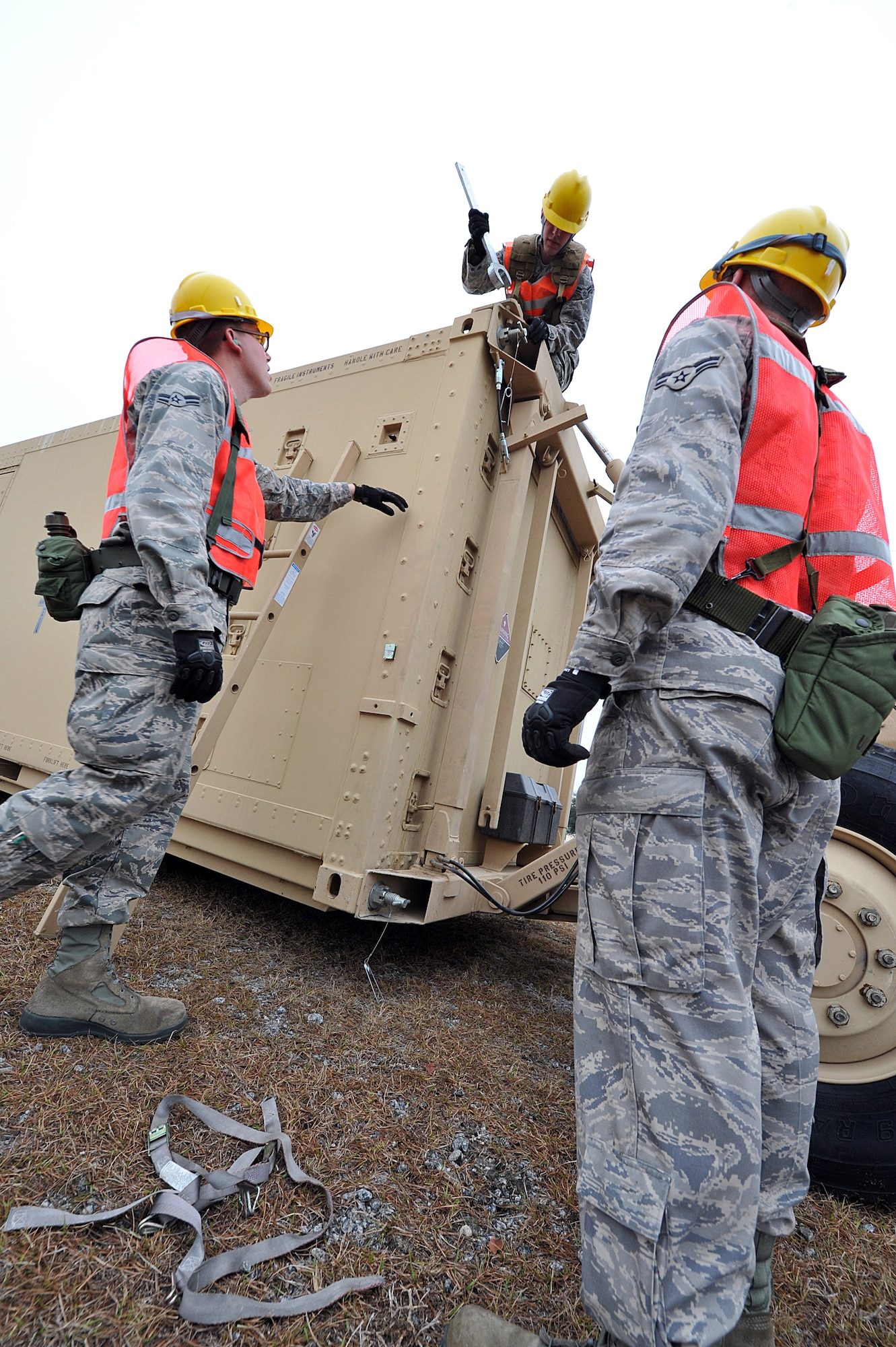 SAVANNAH AIR NATIONAL GUARD BASE, Ga. – Airman 1st Class Mike McClean, Airman 1st Class Dennis Decker and Airman 1st Class Chad Wanner, 52nd Combat Communications Squadron cyber support apprentices, prepare an airport surveillance radar here Jan. 24. The unit began its Arctic Gator field training exercise Jan. 24 and will build, operate in and defend a fully functioning bare base communications camp before the exercise ends Feb. 3. (U.S. Air Force photo by Tommie Horton)