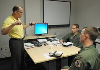 Mr. Len Kight, 14th Operations Support Squadron civilian simulator
instructor, demonstrates a flying technique in Bldg. 738 at Joint
Base San Antonio-Randolph, to Capt. Stephen Montgomery, Jr., and 2nd Lt Howard Shaner, 435th Flying Training Squadron, Jan 24.  Mr. Kight is on temporary duty
assignment to Randolph from Columbus Air Force Base, Miss. to help augment
12th Operations Support Squadron simulator instructors after the
consolidation of the Introduction to Fighter Fundamentals training course.
(U.S. Air Force photo/Joel Martinez)
