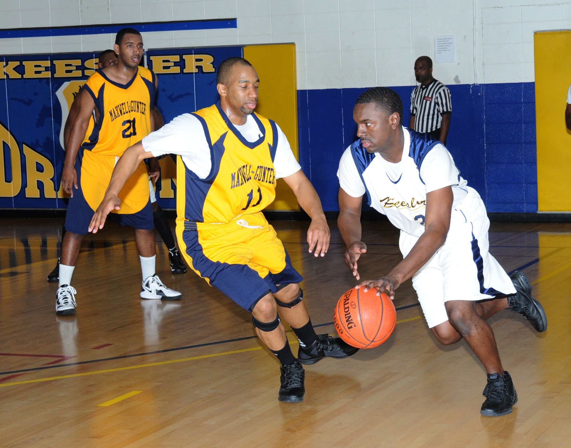 Emanuel Matthew and Brian Cooper, Maxwell-Gunter Air Force Base, Ala., set up a defense against Keesler Dragon Tony Whitley as he drives the ball around the court during a Southeastern Military Athletic Conference varsity basketball game Jan. 21, 2012, at the Blake Fitness Center, Keesler Air Force Base, Miss.  The Maxwell-Gunter Warriors defeated the Keesler Dragons, 73-69.  (U.S. Air Force photo by Kemberly Groue)