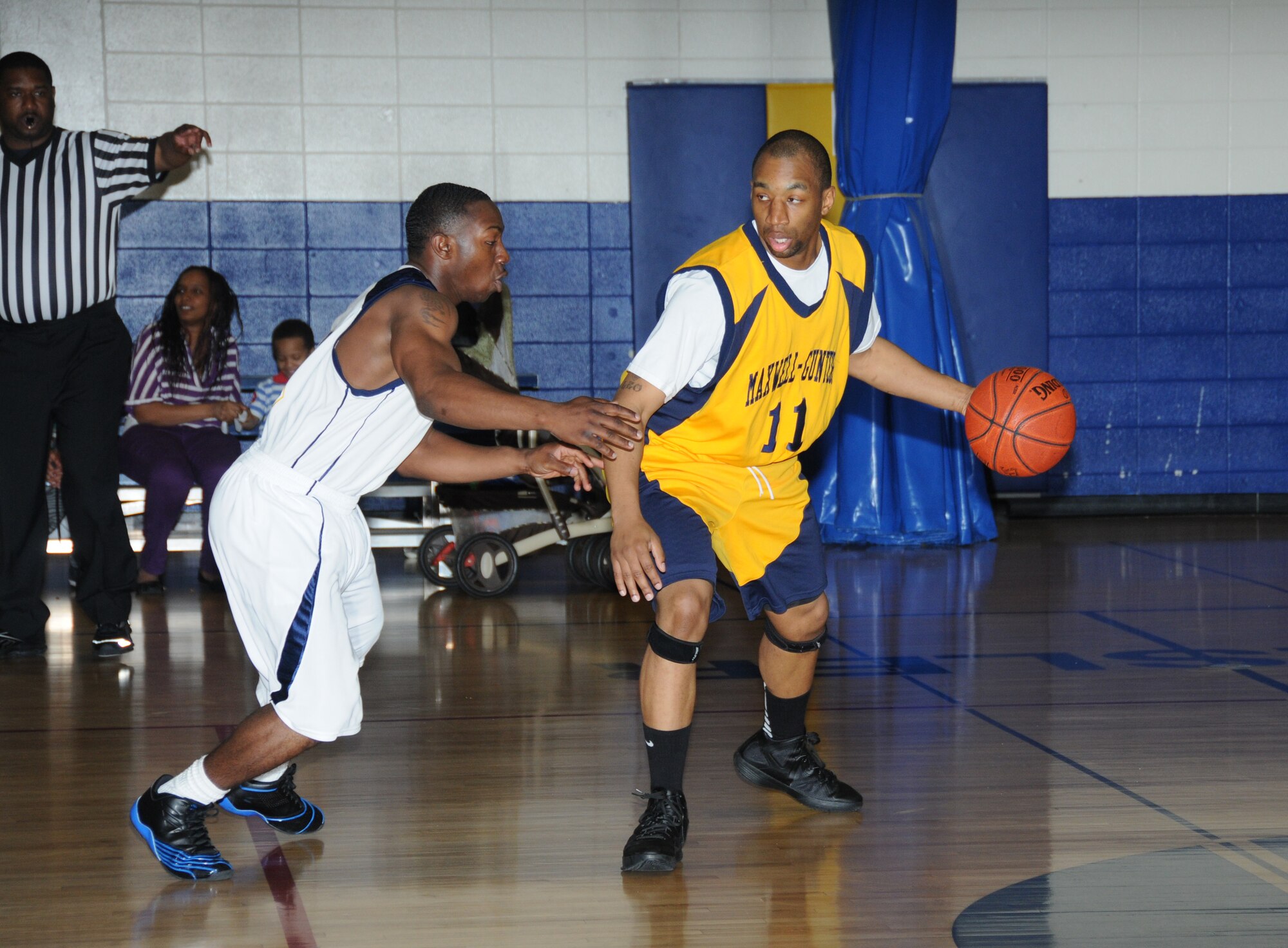 Keesler Dragon Jimmy Glover plays defense against Brian Cooper, Maxwell-Gunter Air Force Base, Ala., as he charges the ball towards the goal during a Southeastern Military Athletic Conference varsity basketball game Jan. 21, 2012, at the Blake Fitness Center, Keesler Air Force Base, Miss.  The Maxwell-Gunter Warriors defeated the Keesler Dragons, 73-69.  (U.S. Air Force photo by Kemberly Groue)