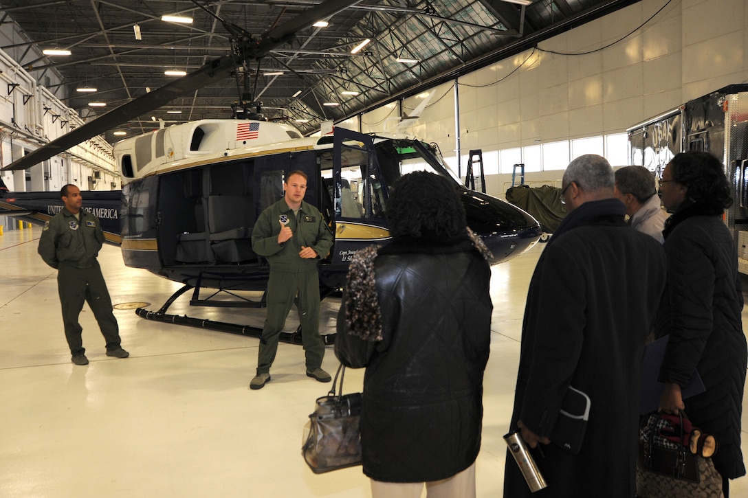 Aircrew members from the 1st Helicopter Squadron brief Joint Base Andrews honorary commanders on the functions of their unit and the capabilities of their airframe, the UH-1N Iroquois Helicopter Jan 20. The honorary commanders were given a tour of the base, which was designed to highlight Andrews assets and its missions to civic leaders and to form positive relationships with the local community. (U.S. Air Force photo/Staff Sgt. Matt Coleman-Foster)