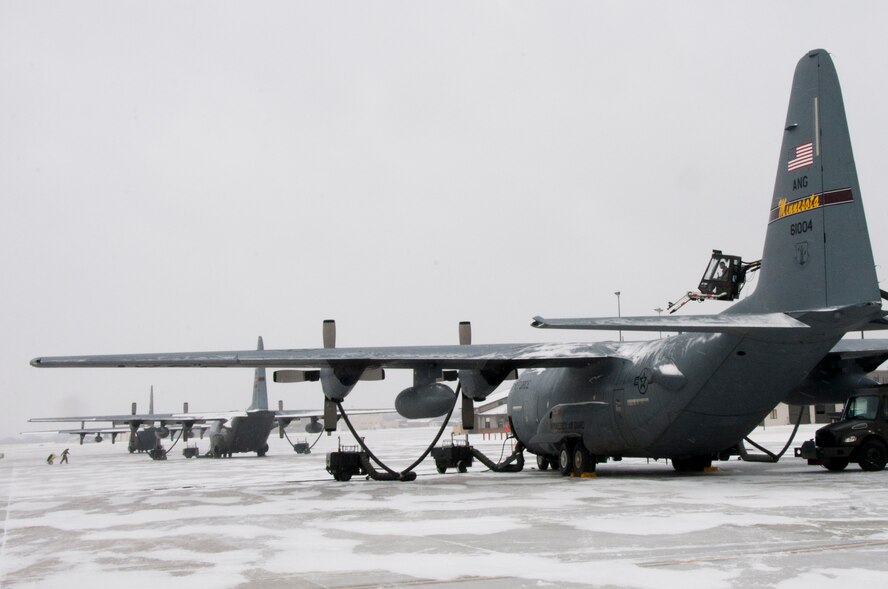 Senior Airman Michael Swenson 133rd Aircraft Maintenance Squadron seated in a deicing truck uses hot air to remove the snow from the tail of a C-130 “Hercules” on the ramp of the Minnesota Air National Guard Base Jan, 23, 2012 in St Paul, Minnesota. The deicing truck provides a high pressure stream of hot air to remove the ice/snow buildup on the aircraft, similar to a leaf blower allowing the use of less deicing fluid. USAF official photo by Tech. Sgt. Erik Gudmundson
