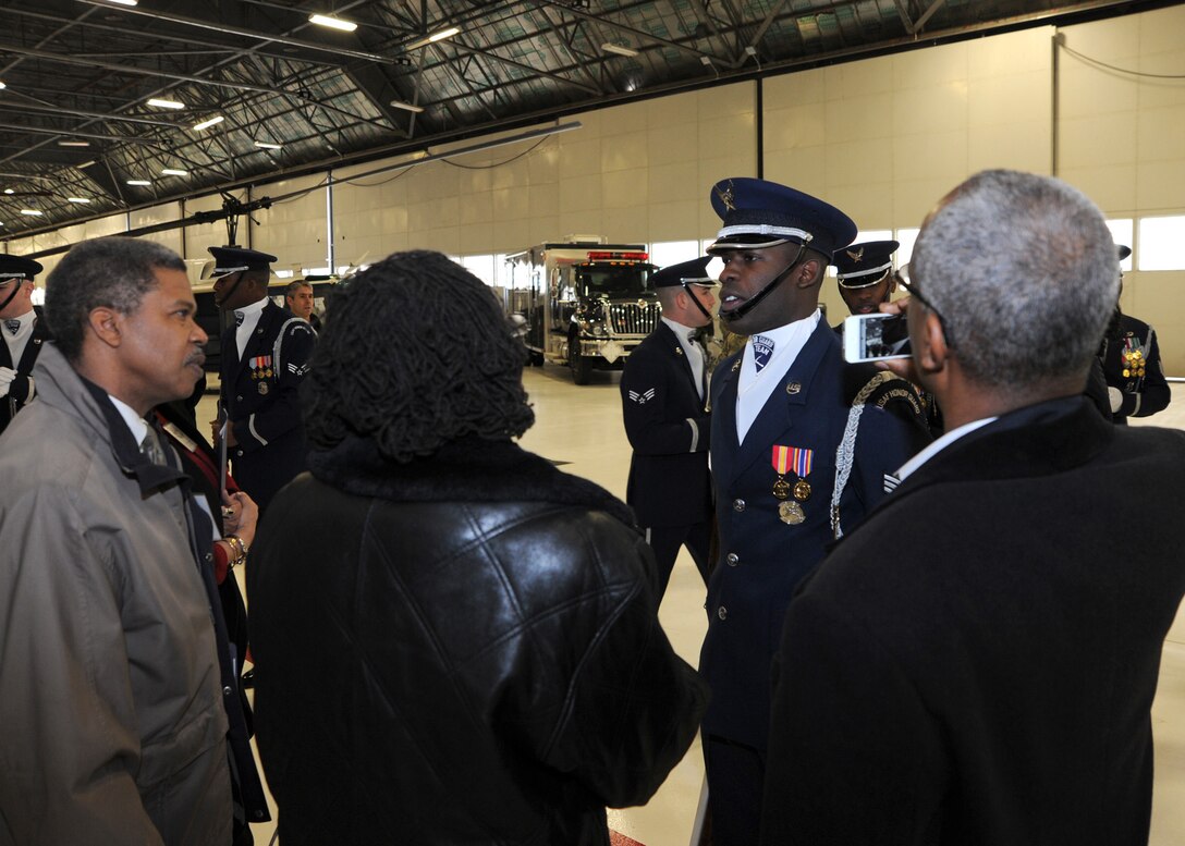 A United States Air Force Honor Guard Drill Team member answers questions from Joint Base Andrews Honorary Commanders after a demonstration of the team’s skill and precision here Jan 20. The honorary commanders were given a tour of the base, which was designed to highlight Andrews assets and its missions to civic leaders and to form positive relationships with the local community. (U.S. Air Force photo/Staff Sgt. Matt Coleman-Foster)