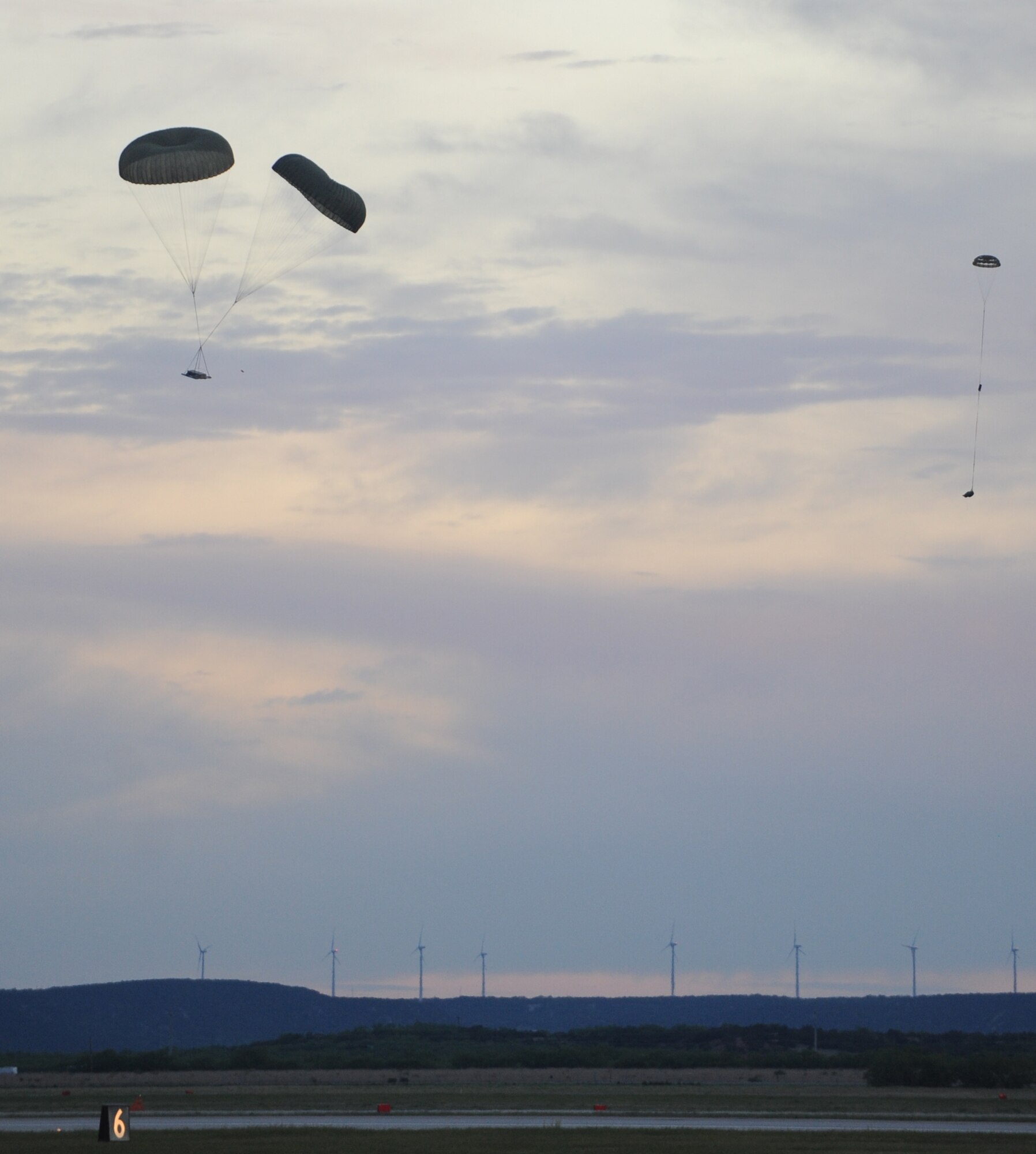 A C-130J conducts an airdrop during low-cost, low-altitude training, May 5, 2011, at Dyess Air Force Base, Texas. An LCLA airdrop is accomplished by dropping bundles weighing 80 to 500 pounds, with pre-packed expendable parachutes, in groups of up to four bundles per pass. (U.S. Air Force photo by Airman 1st Class Courtney Moses/Released)