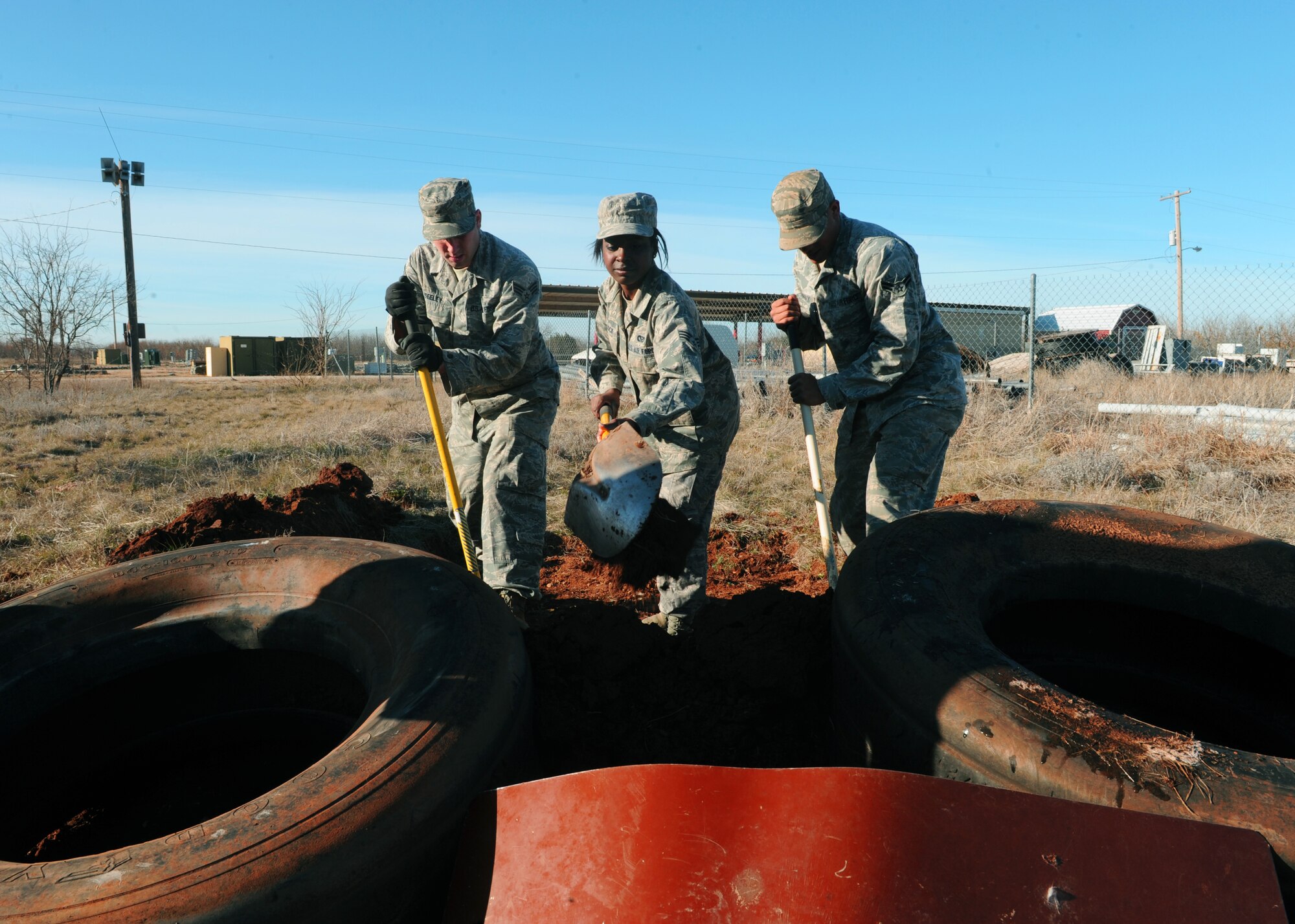 Airmen from the 7th Civil Engineer Squadron dig holes to build defensive fighting positions during readiness training, Jan. 19, 2012, at Dyess Air Force Base, Texas. 7 CES has training once a month to prepare airmen for deployment. Each section of the squadron has its own unique training to include humvee training, tent building, night vision and weapons training. (U.S. Air Force photo by Airman 1st Class Cierra Bullock/Released)