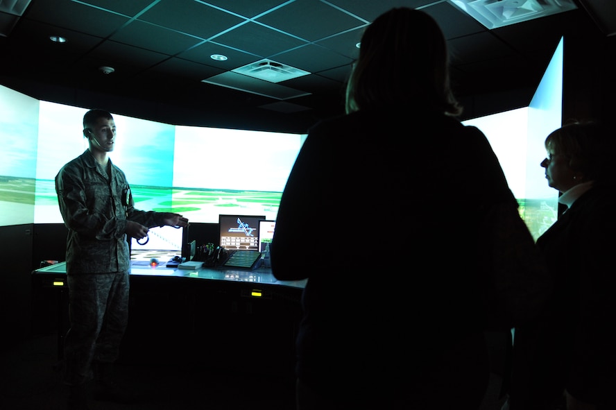 Senior Airman Keoni Kuapahi, an air traffic controller with the 436th Operations Group, showcases the capabilities of the air traffic control simulator during the base's first Military 101 for Educators Tour Jan. 19, 2012, at Dover Air Force Base, Del. Educators from across Kent County, Del., came to Dover AFB to familiarize themselves with base programs meant to benefit military children. (U.S. Air Force photo By Master Sgt. Jeanette Spain)
