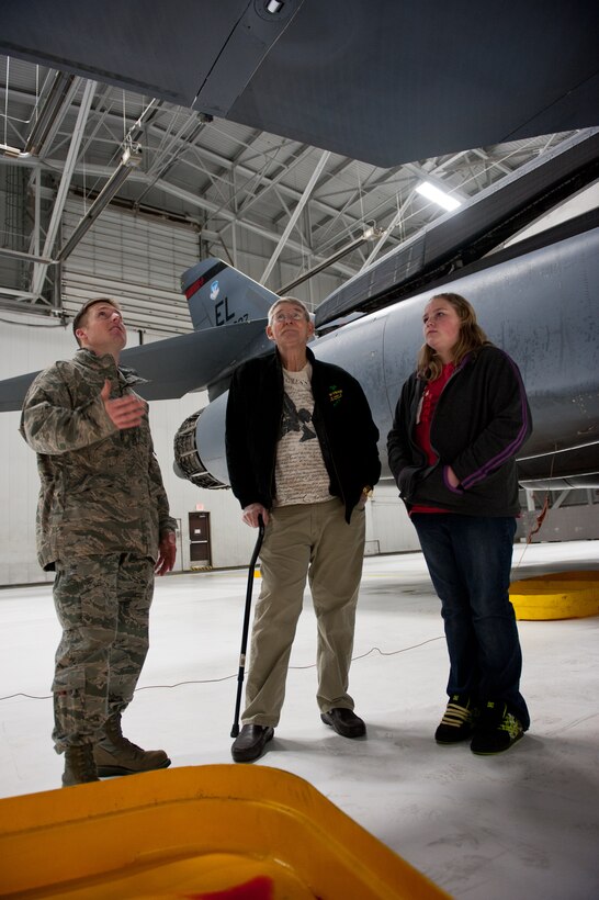 Staff Sgt. Courtney Armstrong, 28th Aircraft Maintenance Squadron crew chief, explains the flight control system of a B-1B to Ed Butler, a medically-retired U.S. Army veteran, and Butler’s granddaughter, Makennah Woods, at Ellsworth Air Force Base, S.D., Jan. 17, 2012. Touring a B-1B was one of Butler’s last wishes after being diagnosed with terminal cancer. (U.S. Air Force photo by Airman 1st Class Kate Thornton/Released)