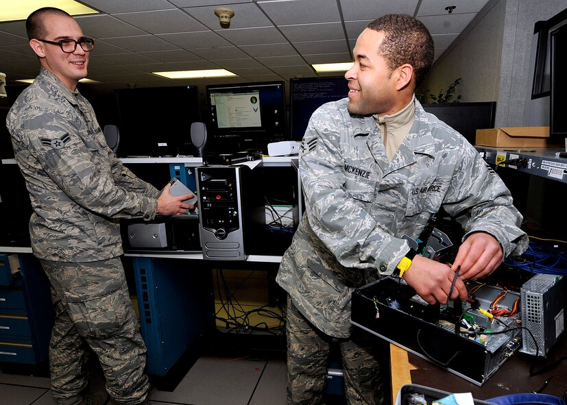 Senior Airman Jason McKenzie, right, disassembles a computer hard drive, as Airman 1st Class Bryan Sutton troubleshoots a power supply failure Jan.
19, 2012 at Dover Air Force Base, Del. McKenzie and Sutton are client
systems technicians with the 436th Communications Squadron. Client system
technicians are computer networking specialists who support Team Dover by
sustaining, troubleshooting and repairing standard voice, data, video
network, and cryptographic client devices locally and in deployed
environments. (U.S. Air Force photo by Tech. Sgt. Chuck Walker)