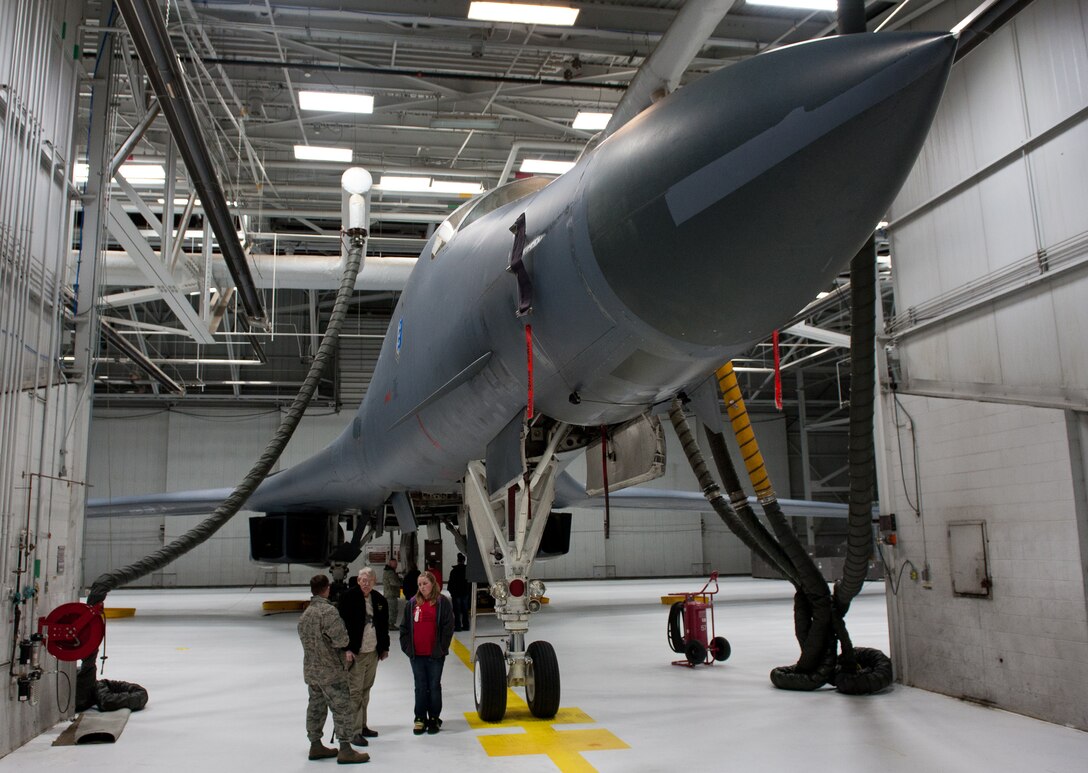 Staff Sgt. Courtney Armstrong, 28th Aircraft Maintenance Squadron crew chief, gives a tour of a B-1B to Ed Butler, a medically-retired U.S. Army veteran, and Butler’s granddaughter, Makennah Woods, at Ellsworth Air Force Base, S.D., Jan. 17, 2012. After being diagnosed with terminal cancer, one of Butler’s last wishes was to see one of Ellsworth’s B-1 bombers upclose. (U.S. Air Force photo by Airman 1st Class Kate Thornton/Released)