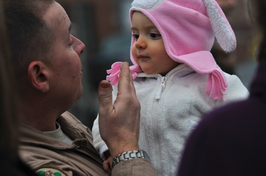 Charlotte, N.C. -- Senior Master Sgt. Derek Rumfelt holds his granddaughter after returning from Afghanistan with several dozen North Carolina Air National Guardsmen. Photo by Tech. Sgt. Brian E. Christiansen