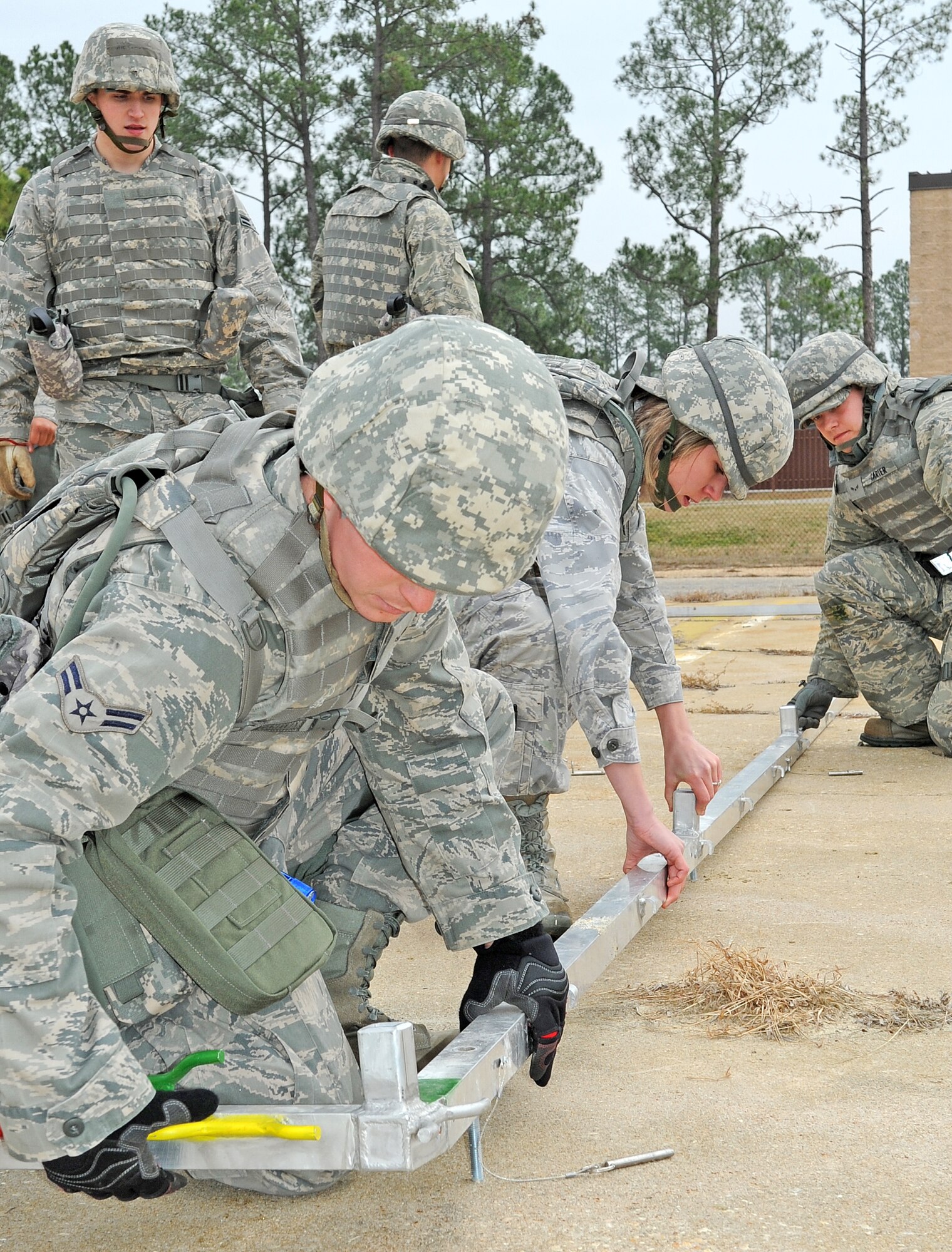 Airmen from the 4th Civil Engineer Squadron infrastructure flight assemble a tent on Base X during a training exercise at Seymour Johnson Air Force Base, N.C., Jan. 23, 2012. The 4th CES conducted this training to practice standing up a forward operating base. (U.S. Air Force photo/Senior Airman Gino Reyes)