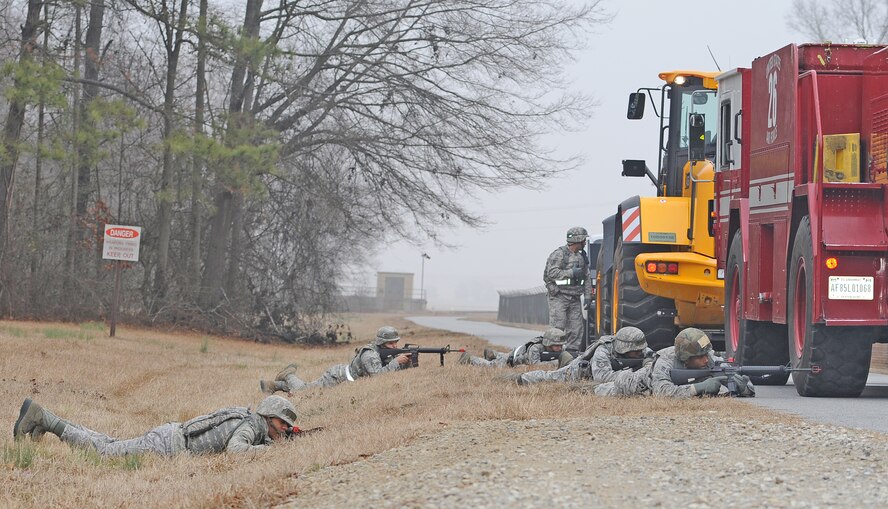 Airmen from the 4th Civil Engineer Squadron take defensive positions during convoy training at Seymour Johnson Air Force Base, N.C., Jan. 23, 2012. The training exposes Airmen to a variety of scenarios such as simulated improvised explosive devices which test response time and reactions. (U.S. Air Force photo/Senior Airman Gino Reyes)
