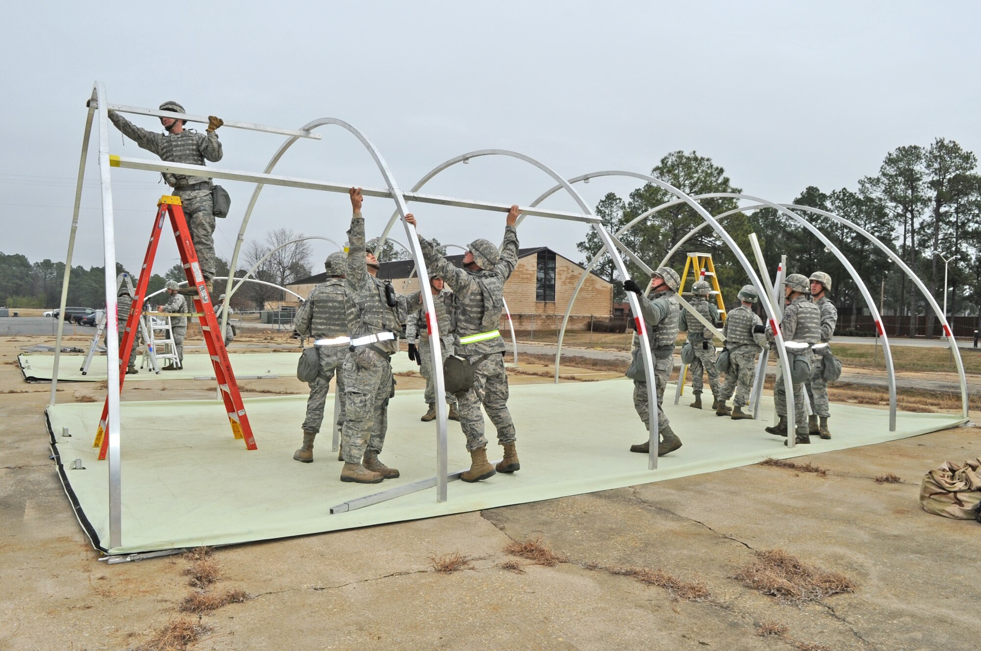 Airmen from the 4th Civil Engineer Squadron construct a tent during the 4th CES internal training exercise at Seymour Johnson Air Force Base, N.C., Jan. 23, 2012. The 4th CES conducts internal training to prepare Airmen for future operational readiness inspections. (U.S. Air Force photo/Senior Airman Gino Reyes)