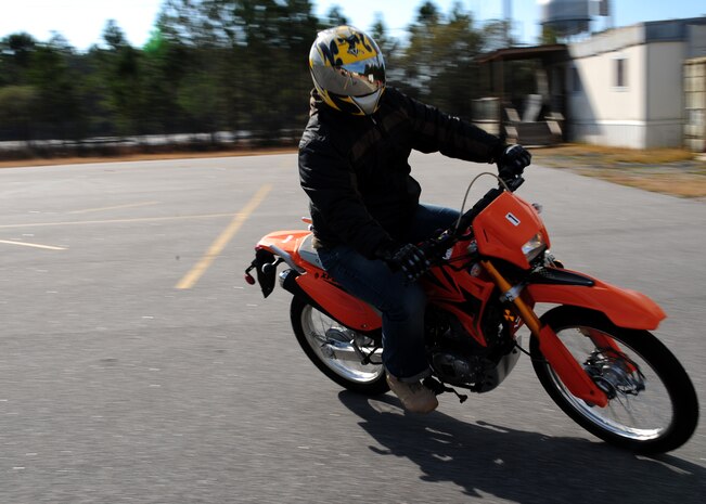 Master Sgt. Charles Thompson performs a move during the Basic Rider Course at Joint Base Charleston - Weapons Station, Jan. 19. The motorcycle course allows riders to become more competent with their bike in a controlled environment which is significantly safer than public roads. Thompson is a logistics superintendent with the 628th Security Forces Squadron. (U.S. Air Force photo/Staff Sgt. Katie Gieratz)(RELEASED)
