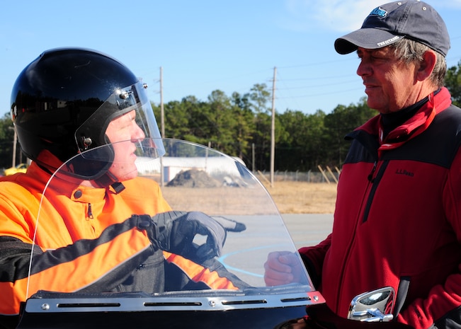 Skip Evans speaks to Navy chief petty officer Stephen Walz during the Basic Rider Course at Joint Base Charleston - Weapons Station, Jan. 19. There are three courses provided to JB Charleston personnel by Cape Fox; the basic rider course, a refresher course and a military sports bike course. More than 35 students attend the courses each month. Evans is a rider coach with Cape Fox, a contractor for the Air Force Installation’s Motorcycle Safety Programs and Walz is a Religious Program Specialist assigned to the JB Charleston - Weapons Station Chaplain’s office. (U.S. Air Force photo/Staff Sgt. Katie Gieratz)(Released)
