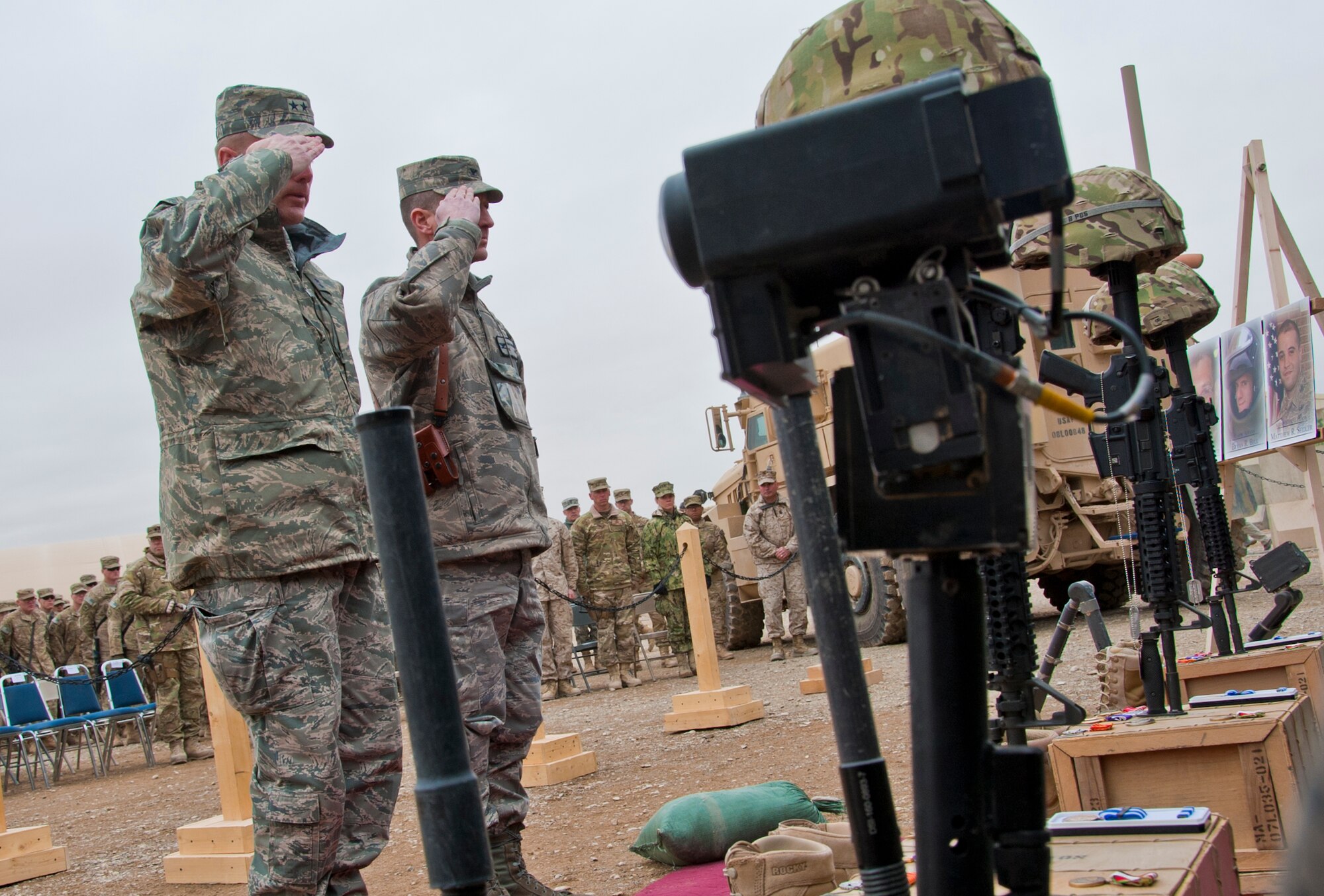 CAMP LEATHERNECK, Afghanistan -- Maj. Gen. Tod Wolters, 9th Air and Space Expeditionary Task Force – Afghanistan commander, and Col. Brian Hastings, 9th Air and Space Expeditionary Task Force – Afghanistan deputy commander, render salutes to the Battle Crosses of three fallen Airmen during a memorial ceremony at Camp Leatherneck, Afghanistan Jan. 24, 2012. The three Airmen were explosive ordnance disposal technicians who were killed Jan. 5 by an improvised explosive device in Shir ghazi, Helmand province, Afghanistan. (U.S. Air Force photo by Staff Sgt. David Carbajal)