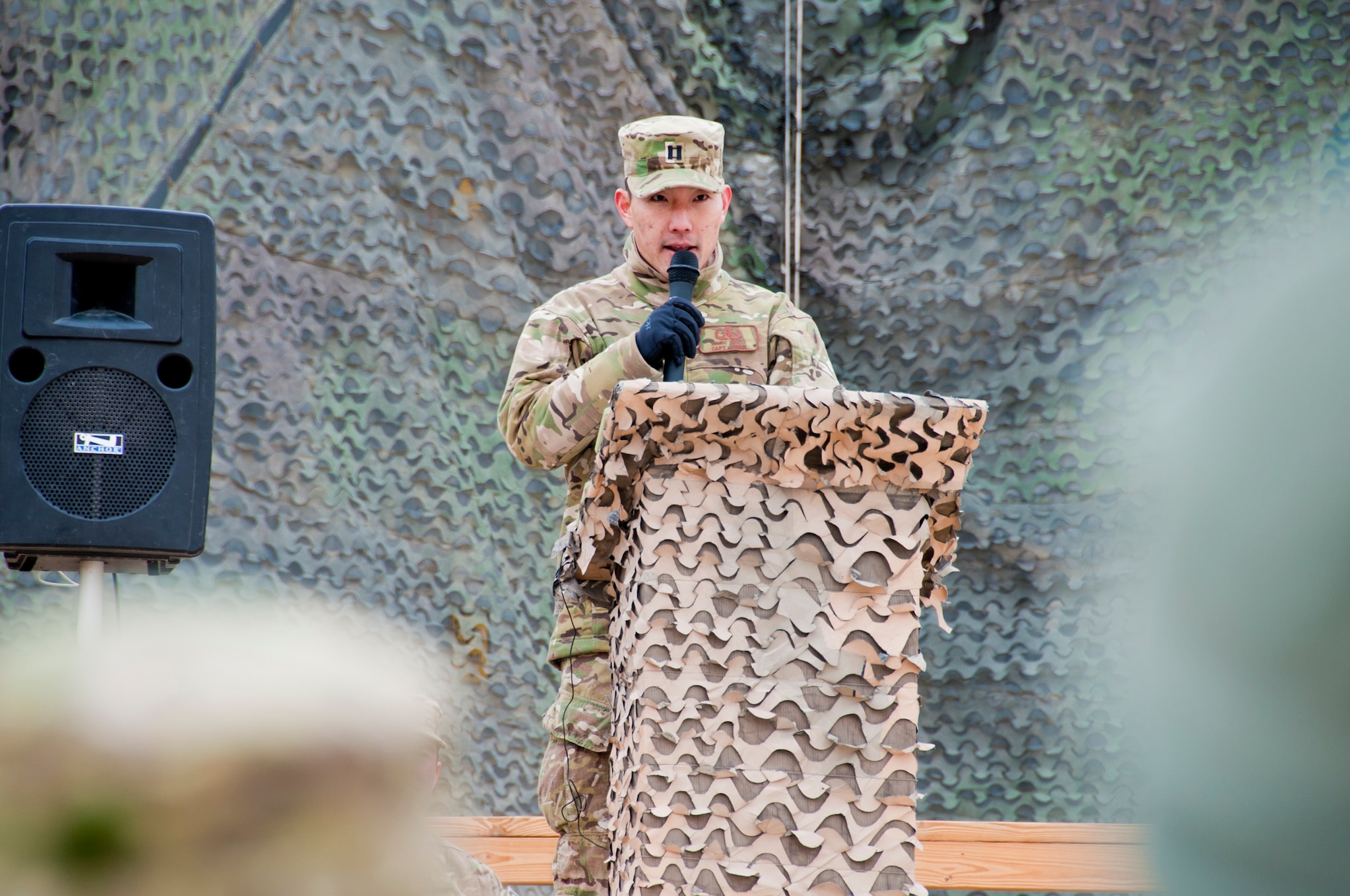 CAMP LEATHERNECK, Afghanistan -- Capt. Mark Sakai, Combined Joint Task Force Paladin explosive ordnance disposal flight commander, speaks to attendees at a memorial ceremony at Camp Leatherneck, Afghanistan Jan. 24, 2012. Sakai spoke about the character of each of his fallen Airmen who were killed Jan. 5 by an improvised explosive device in Shir ghazi, Helmand province, Afghanistan. (U.S. Air Force photo by Staff Sgt. David Carbajal)