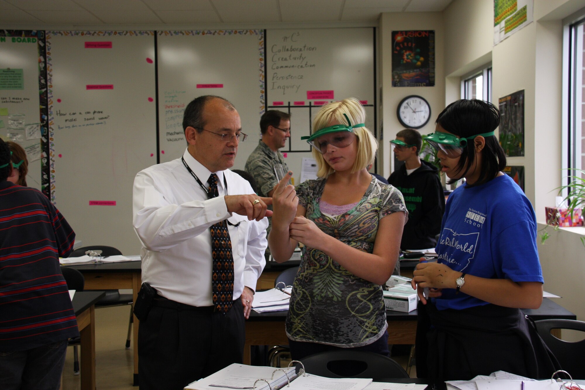 Mr. Ricardo Negron of the Air Force Research Laboratory discusses the effects of corrosion on different metals with 8th grade students at the Dayton Regional STEM School. (U.S. Air Force photo)
