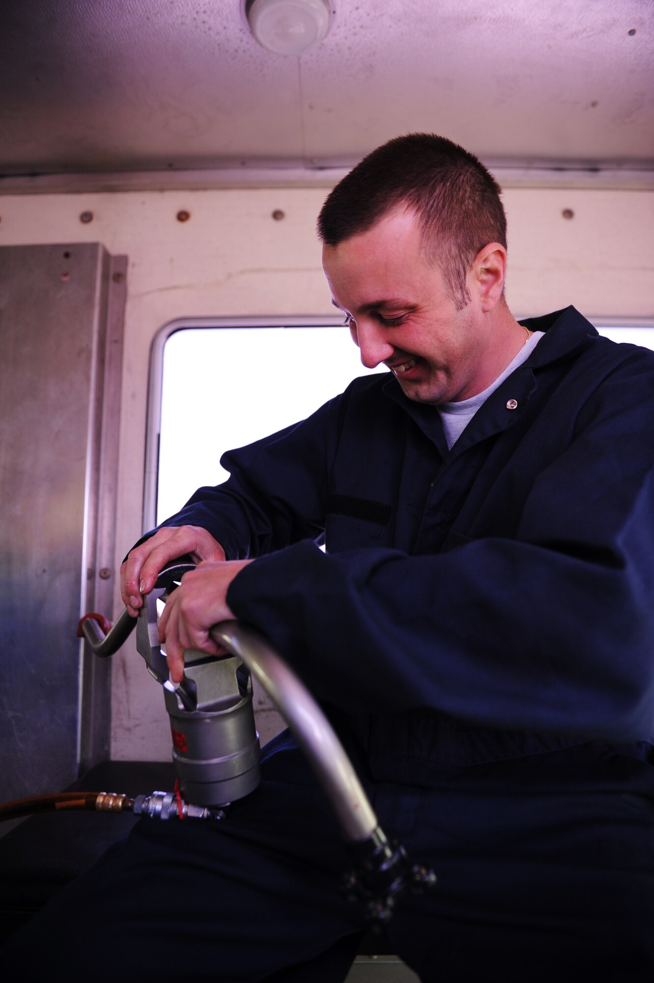 SOUTHWEST ASIA – Staff Sgt. Brian Harrison, 379th Expeditionary Maintenance Squadron Fabrication Flight sheet metals technician, steadies a clamp as he splices two pieces of pressure line together here Jan. 21, 2012. The new piece was custom-made by Harrison and Staff Sgt. Jason Hayden. Harrison is a native of Minneapolis and is deployed from Ellsworth Air Force Base, S.D.  (U.S. Air Force photo/Staff Sgt. Nathanael Callon)