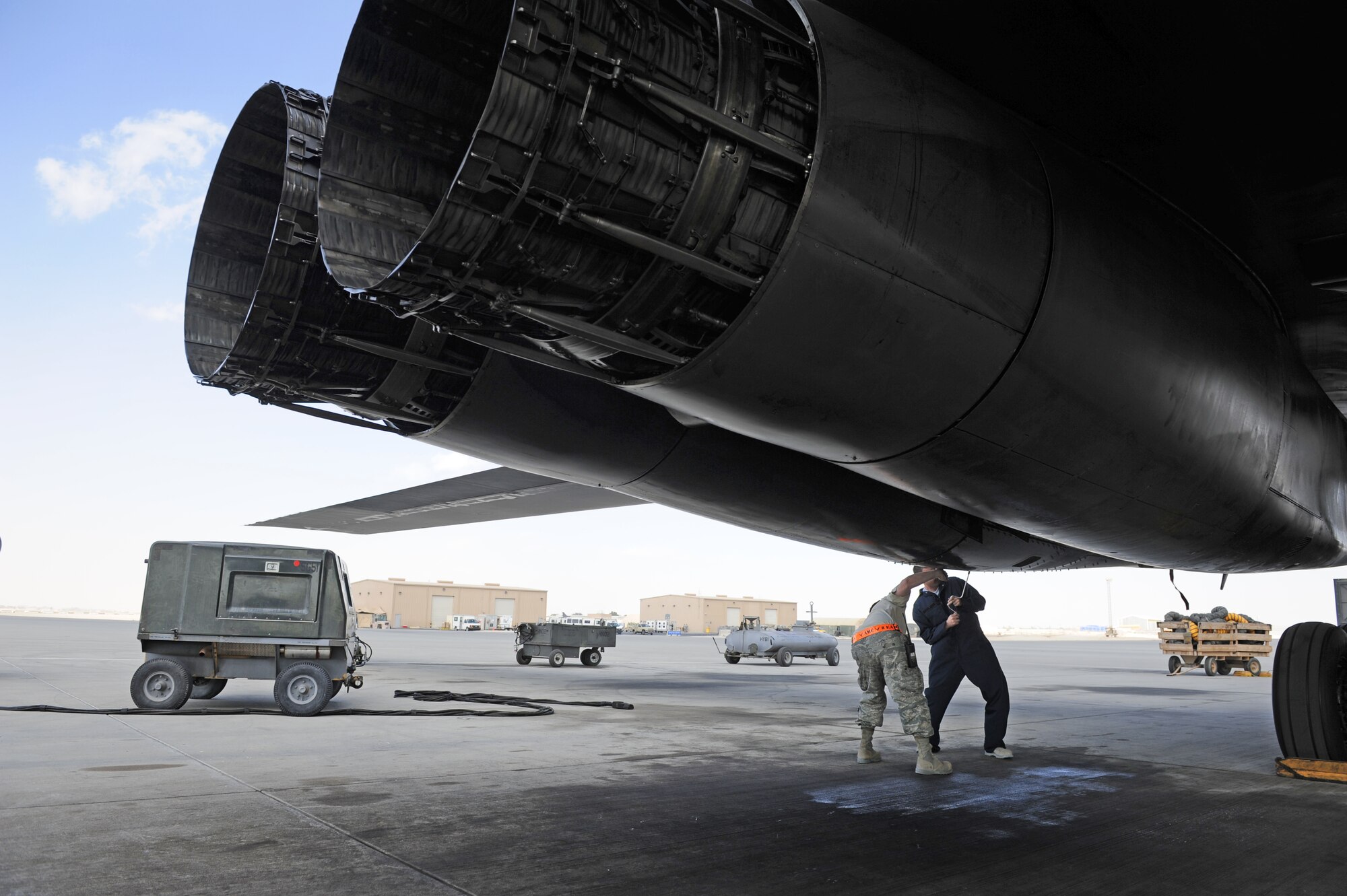 SOUTHWEST ASIA – Staff Sgts. Jason Hayden and Brian Harrison, 379th Expeditionary Maintenance Squadron sheet metals technicians, unscrew a compartment door on a B-1B Lancer here Jan. 21, 2012. The pressure line on the hydraulic system had a leak and need to be replaced. The technicians custom-made a new line and spliced it into the existing lines. Hayden is a native of Waretown, N.J. and Harrison is a native of Minneapolis. (U.S. Air Force photo/Staff Sgt. Nathanael Callon)