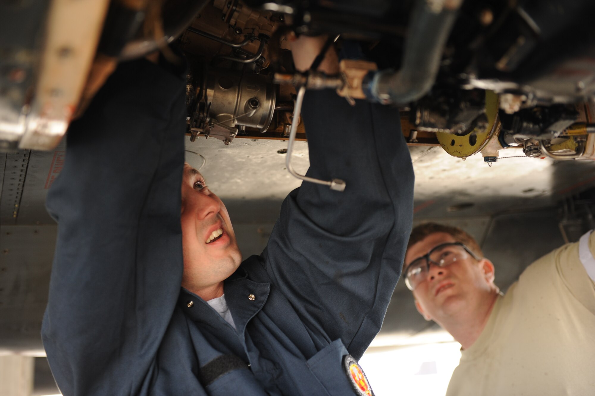 SOUTHWEST ASIA – Staff Sgts. Jason Hayden and Brian Harrison, 379th Expeditionary Maintenance Squadron sheet metals technicians, attach a new piece of pressure line to a hydraulic system inside a B-1B Lancer here Jan. 21, 2012. The technicians custom-made a new line and spliced it into the existing lines. Hayden is a native of Waretown, N.J. and Harrison is a native of Minneapolis. (U.S. Air Force photo/Staff Sgt. Nathanael Callon)