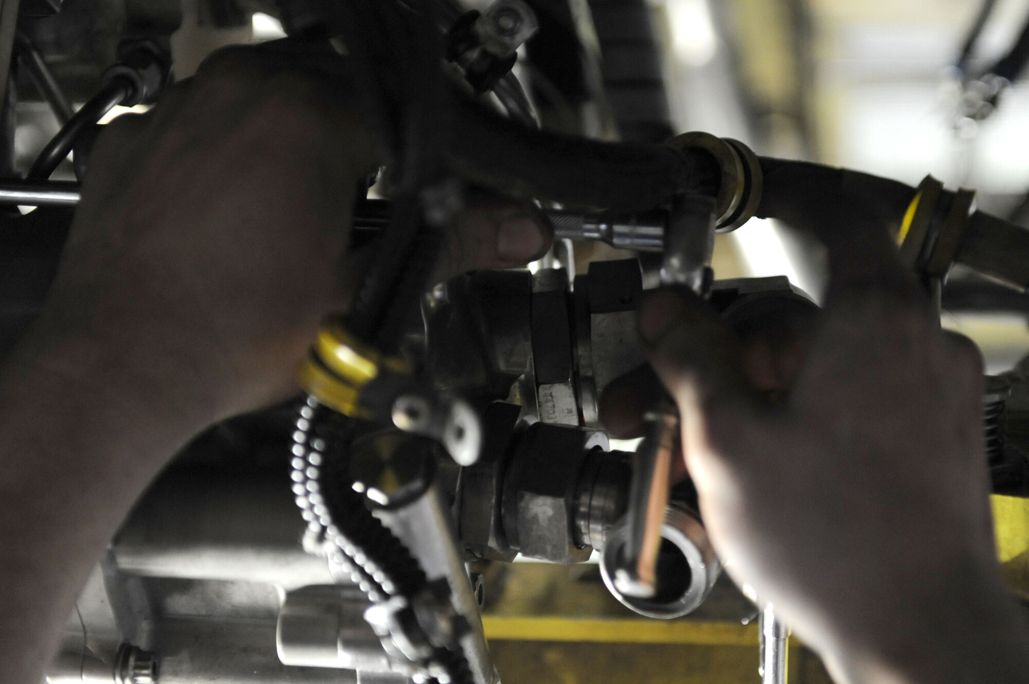 SPANGDAHLEM AIR BASE, Germany – Senior Airman Michael Wylie, 52nd Aircraft Maintenance Squadron tactical aircraft maintainer, installs jet-fuel starter fuel valves on an F-16 Fighting Falcon during maintence in Hangar 2 here Jan. 23. Airmen perform maintence daily with different aircraft rotations to ensure the health of the 52nd Fighter Wing fleet. Wylie works to provide the wing mission-capable aircraft through scheduled maintenance as part of the 480th Aircraft Maintenance Unit. (U.S. Air Force photo / Senior Airman Christopher Toon)