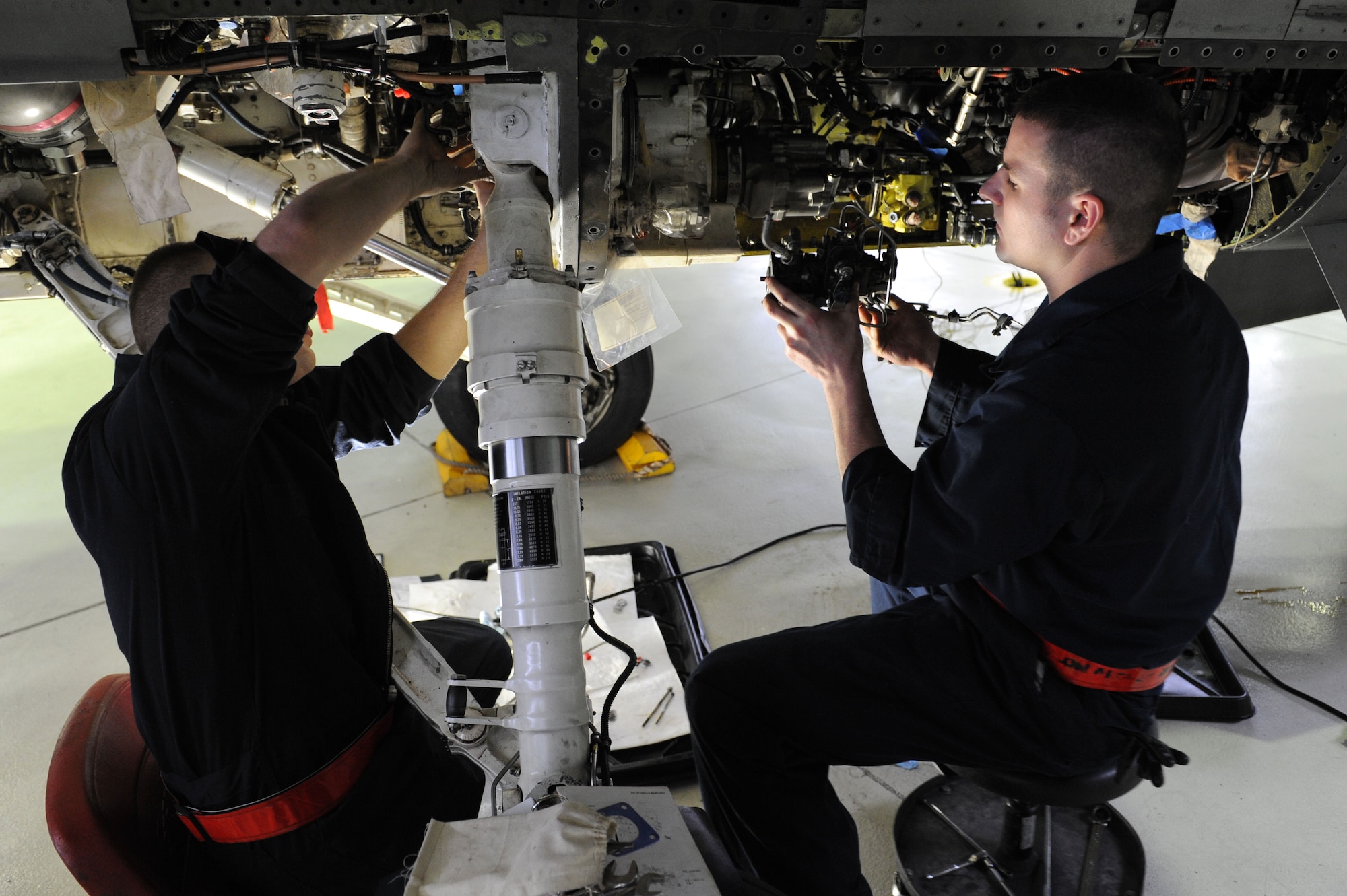 SPANGDAHLEM AIR BASE, Germany – Senior Airman Michael Wylie and Staff Sgt. Michael Klucar, 52nd Aircraft Maintenance Squadron tactical aircraft maintainers, install a jet-fuel starter fuel control assembly during maintenance on an F-16 Fighting Falcon in Hangar 2 here Jan. 23. Airmen perform maintence daily with different aircraft rotations to ensure the health of the 52nd Fighter Wing fleet. Wylie and Frederick work to provide the wing mission-capable aircraft through scheduled maintenance as part of the 480th Aircraft Maintenance Unit. (U.S. Air Force photo/Senior Airman Christopher Toon)